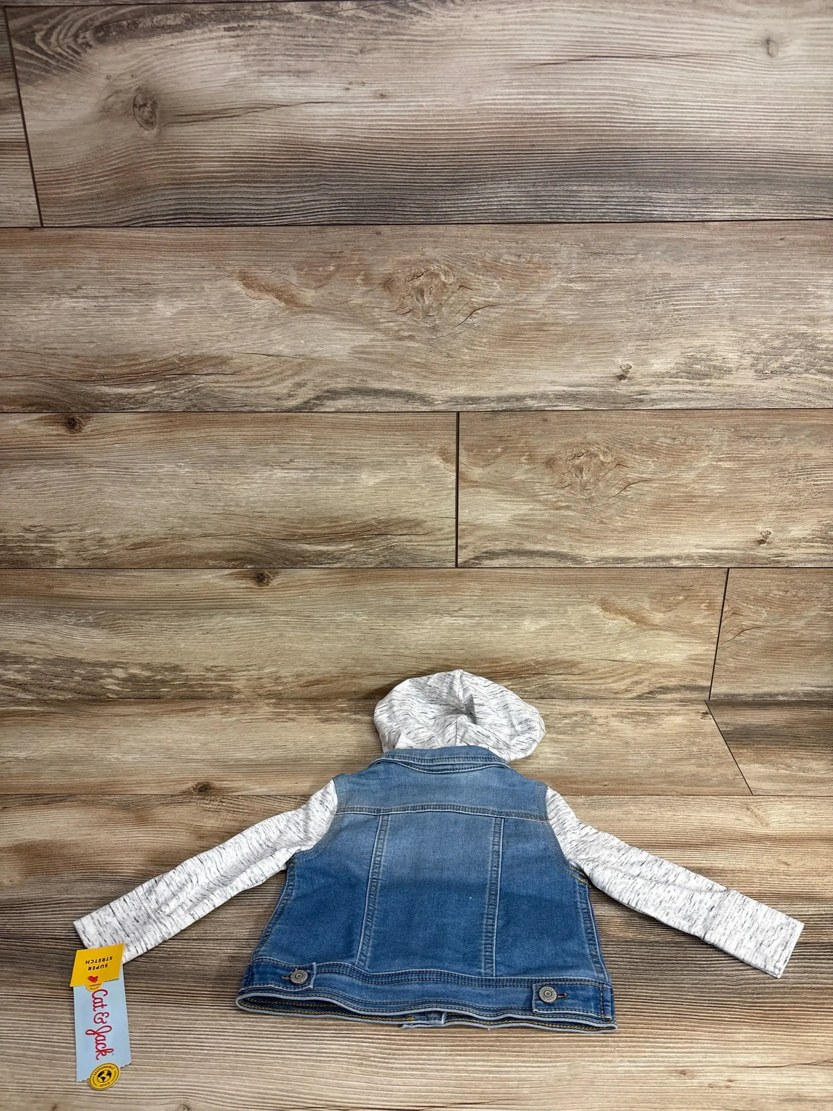 Kids' denim jacket with gray hood and sleeves, laid flat on wood background, Cat & Jack tag
