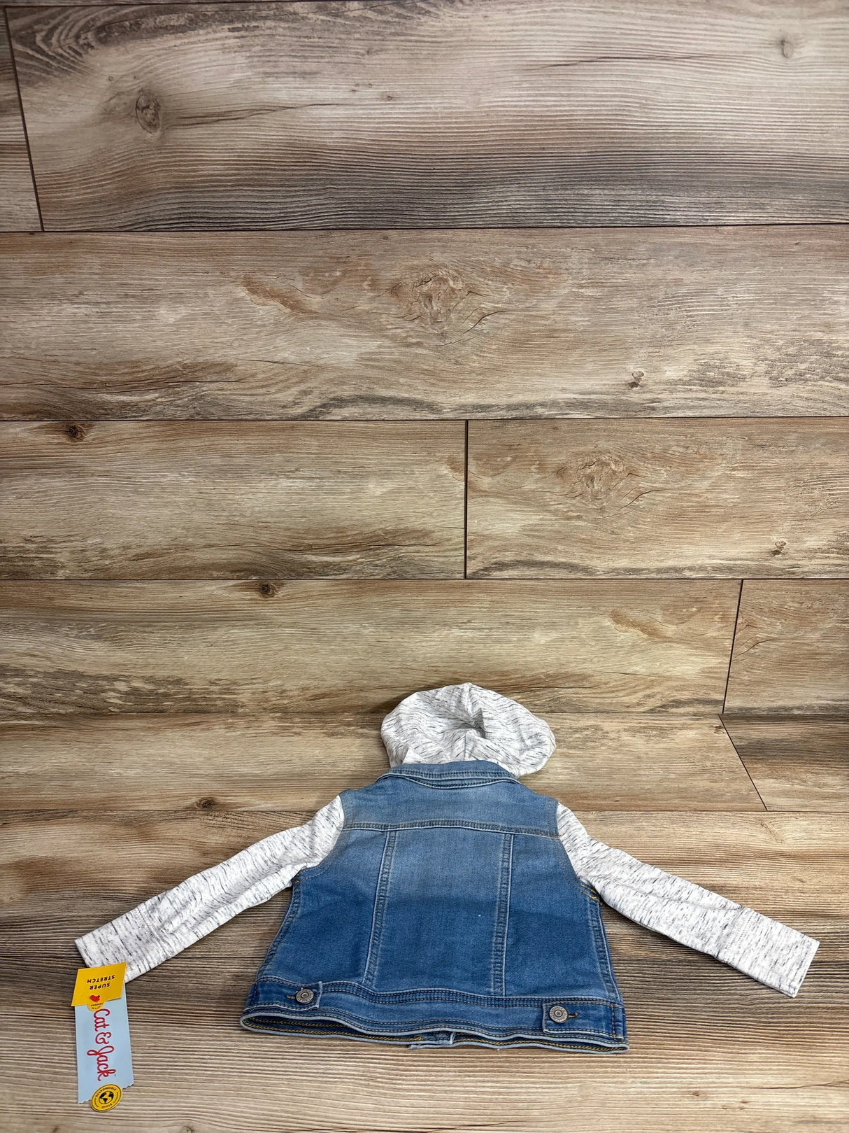 Kids' denim jacket with gray hood and sleeves, laid flat on wood background, Cat & Jack tag