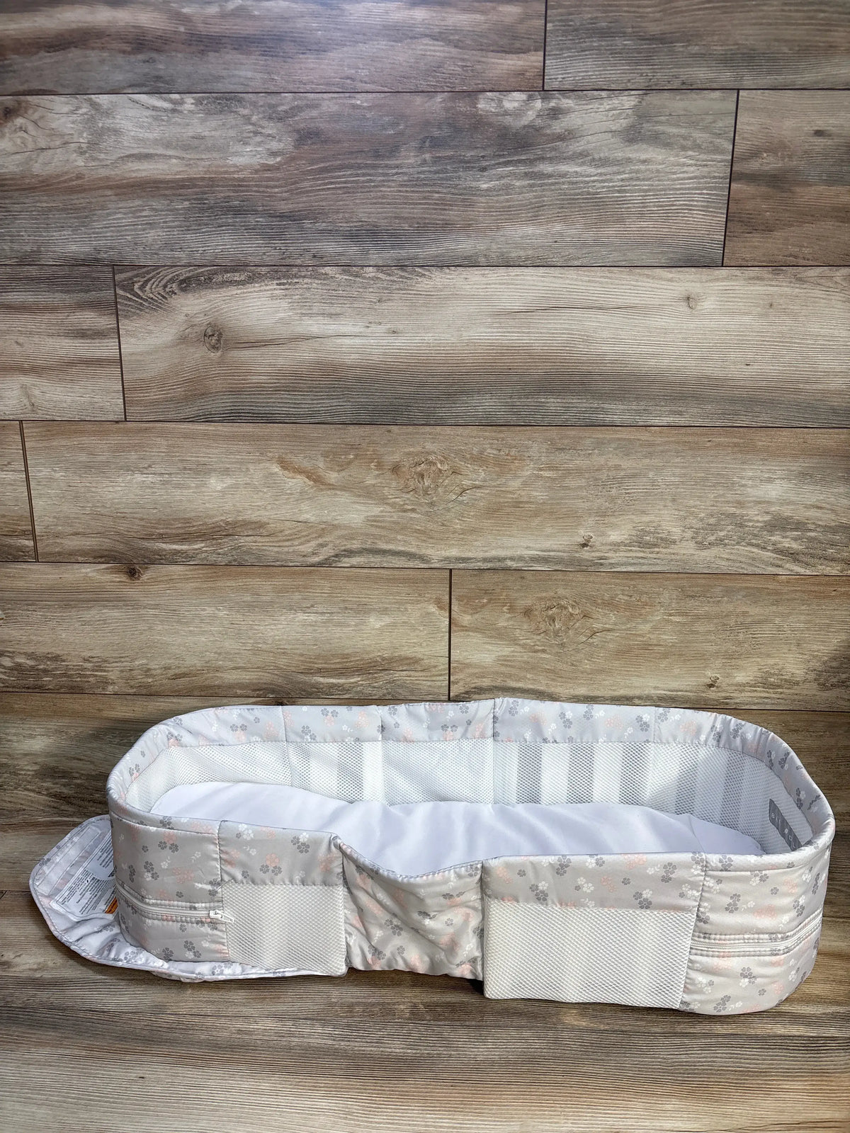 Front view of Baby Delight Snuggle Nest Harmony infant lounger with comfort-mesh walls and floral sides