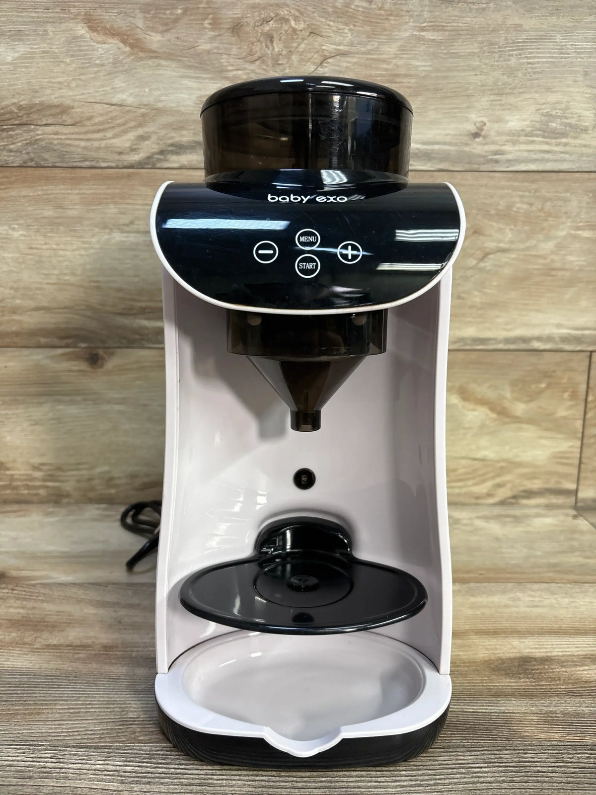 Front view of Baby EXO Smart Formula Maker/Dispenser showcasing its powder hopper, dispensing nozzle, and drip tray