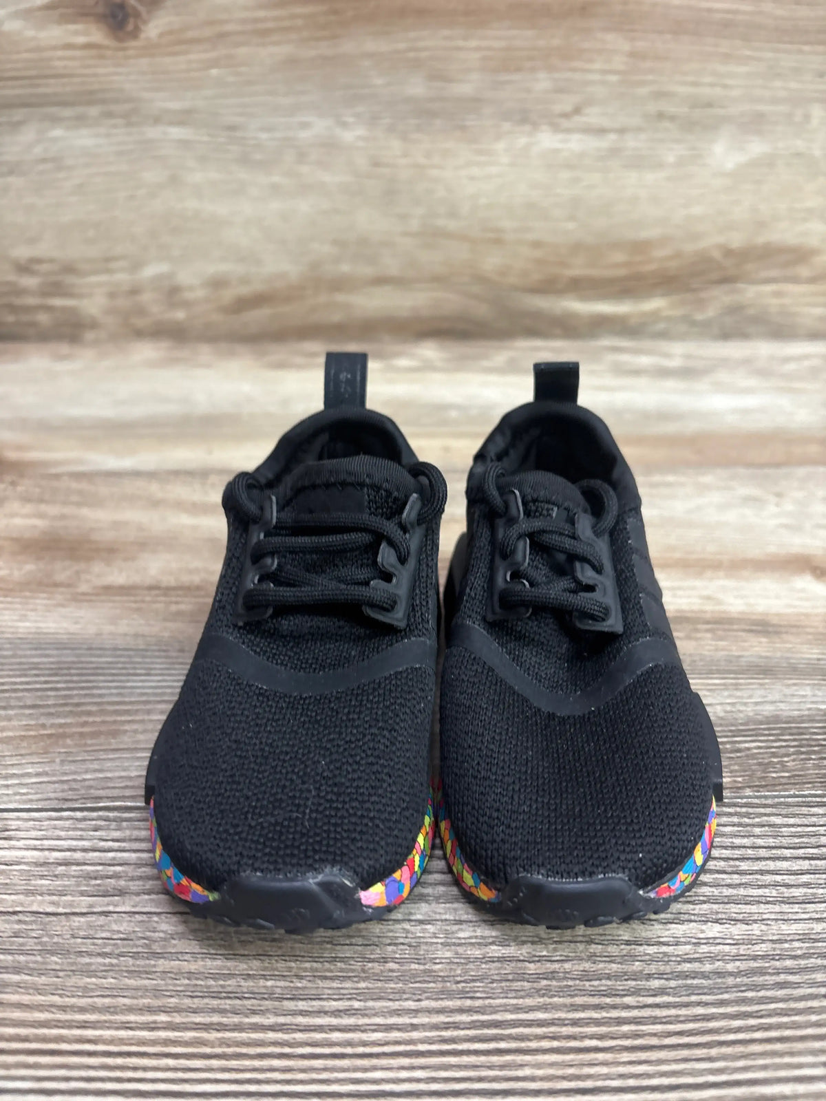 Adidas NMD_R1 El Mosaic black toddler sneakers with colorful speckled soles.