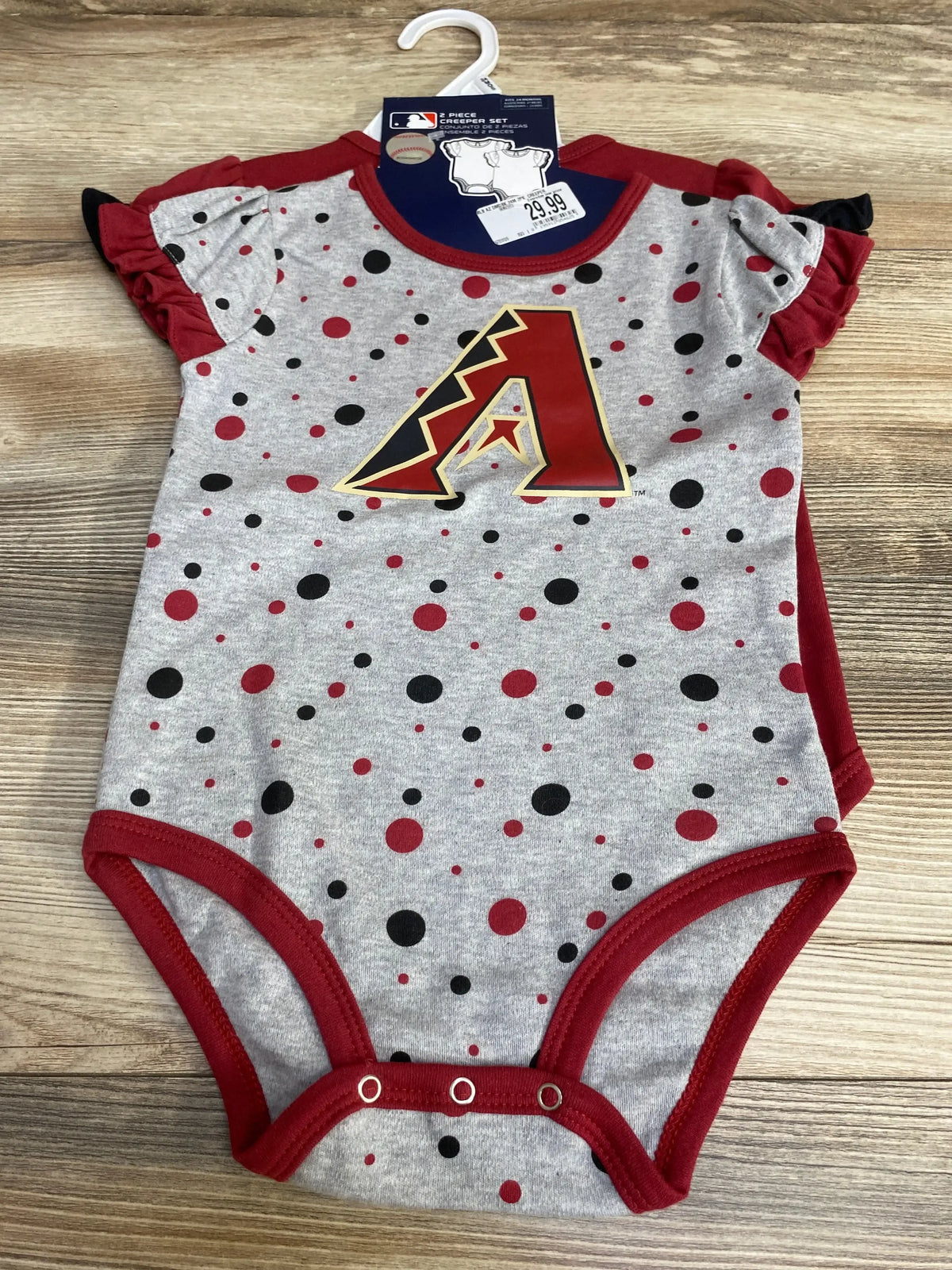 Flat lay of Arizona Diamondbacks infant creeper set: gray polka-dot bodysuit with red trim, team A logo, snaps