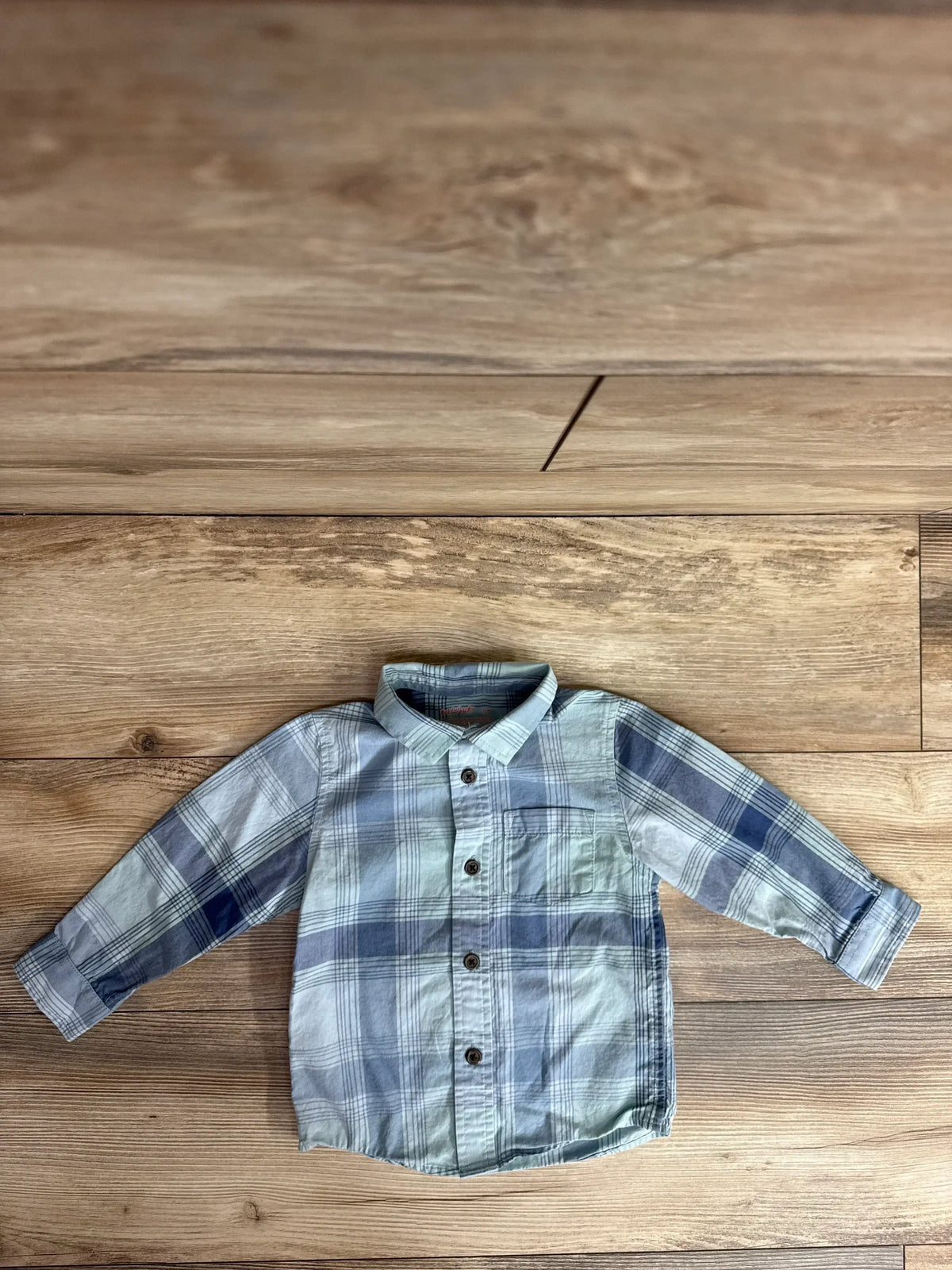 Front view of toddler blue plaid Cat and Jack button-up shirt showing button front, chest pocket, and long sleeves on white background