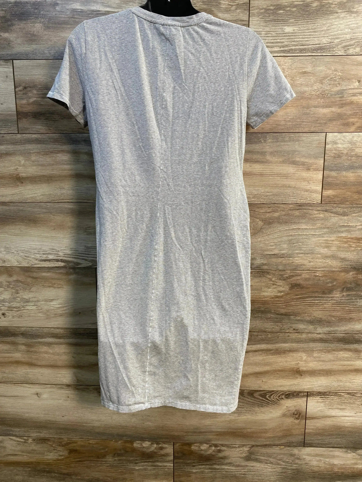 Back of A Pea In The Pod grey striped dress showing short sleeves and knee-length on mannequin with wood backdrop