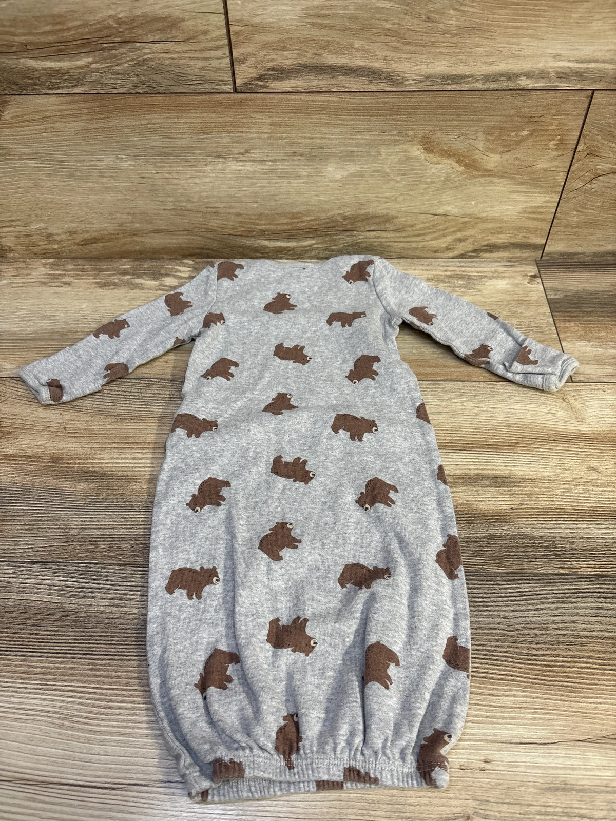 Front view of Simple Joys sleep sack in grey, size 0-3m, with long sleeves and brown bear print on wood floor