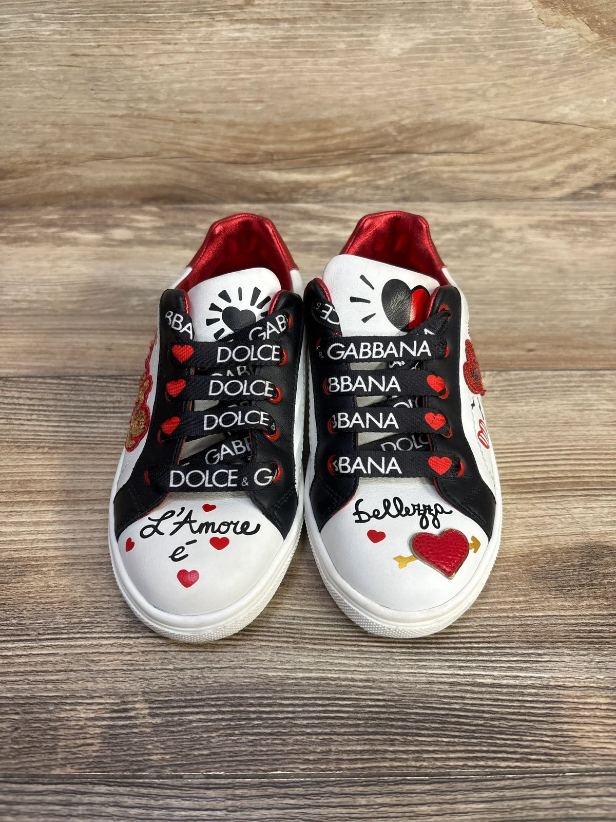 Top view of Dolce & Gabba Portofino DG Amore sneakers showcasing white calfskin uppers, branded laces, red lining, and heart graphics
