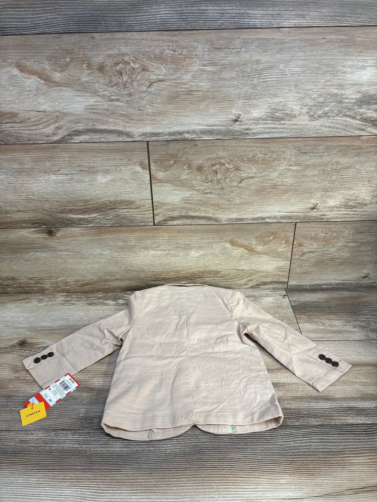 Beige toddler stretch blazer with buttons, new with tags, displayed on wood background