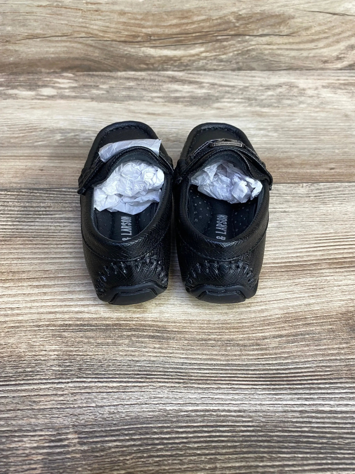 Side view of black Curt and Larson toddler loafers size 5C showing rounded toe and slip on design on white background