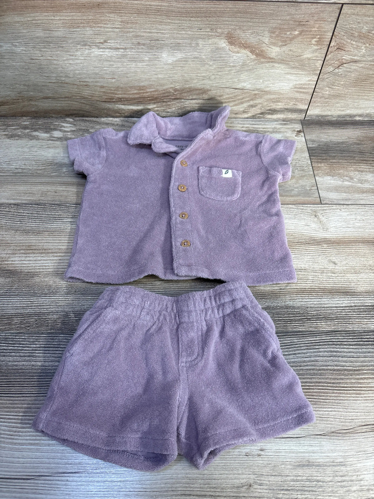 Top view of Easy Peasy 2-piece terry cloth shirt and shorts set showcasing front buttons, chest pocket, and elastic waistband