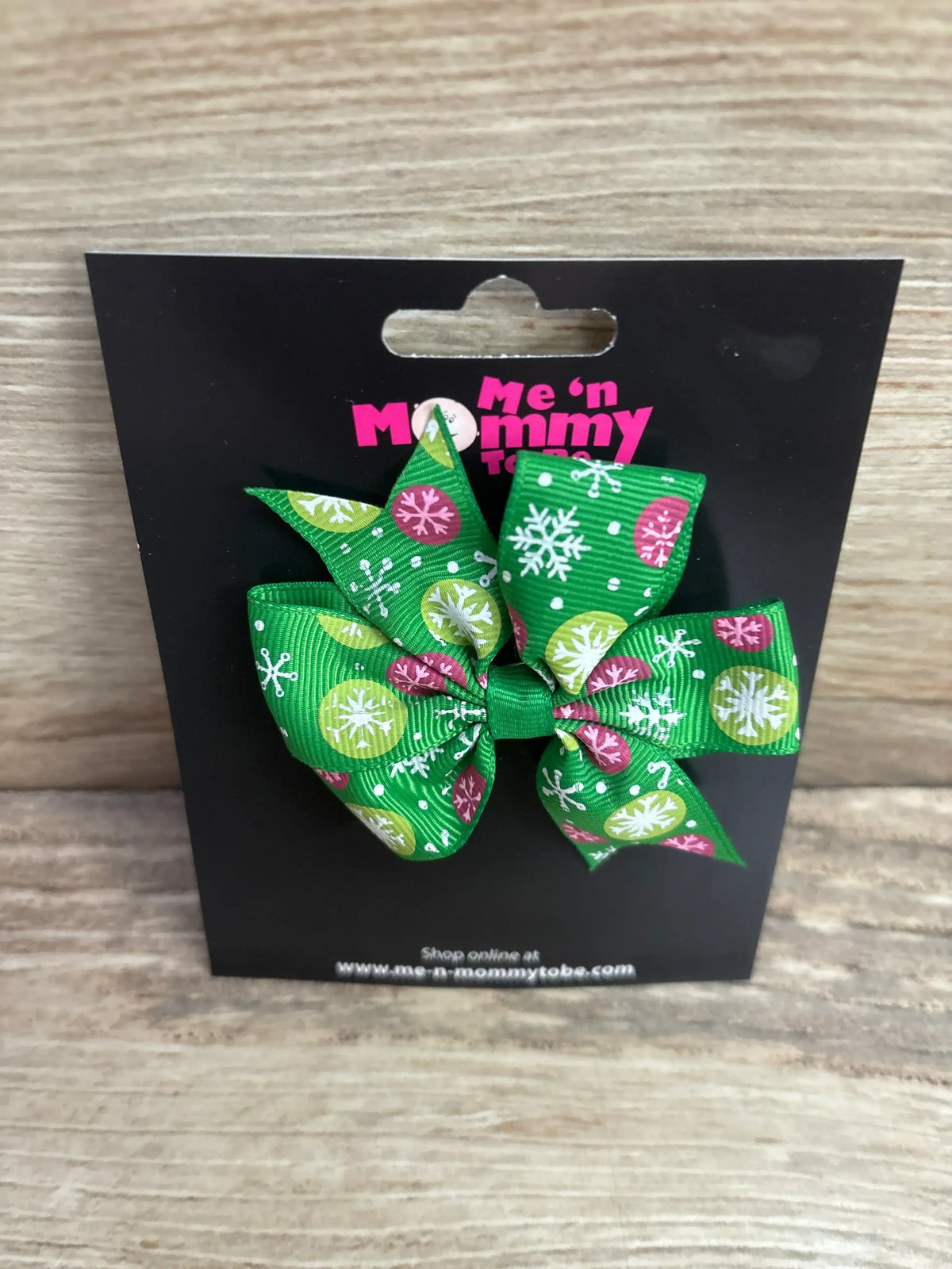 Green holiday bow with snowflake and circle patterns for kids, festive Christmas accessory