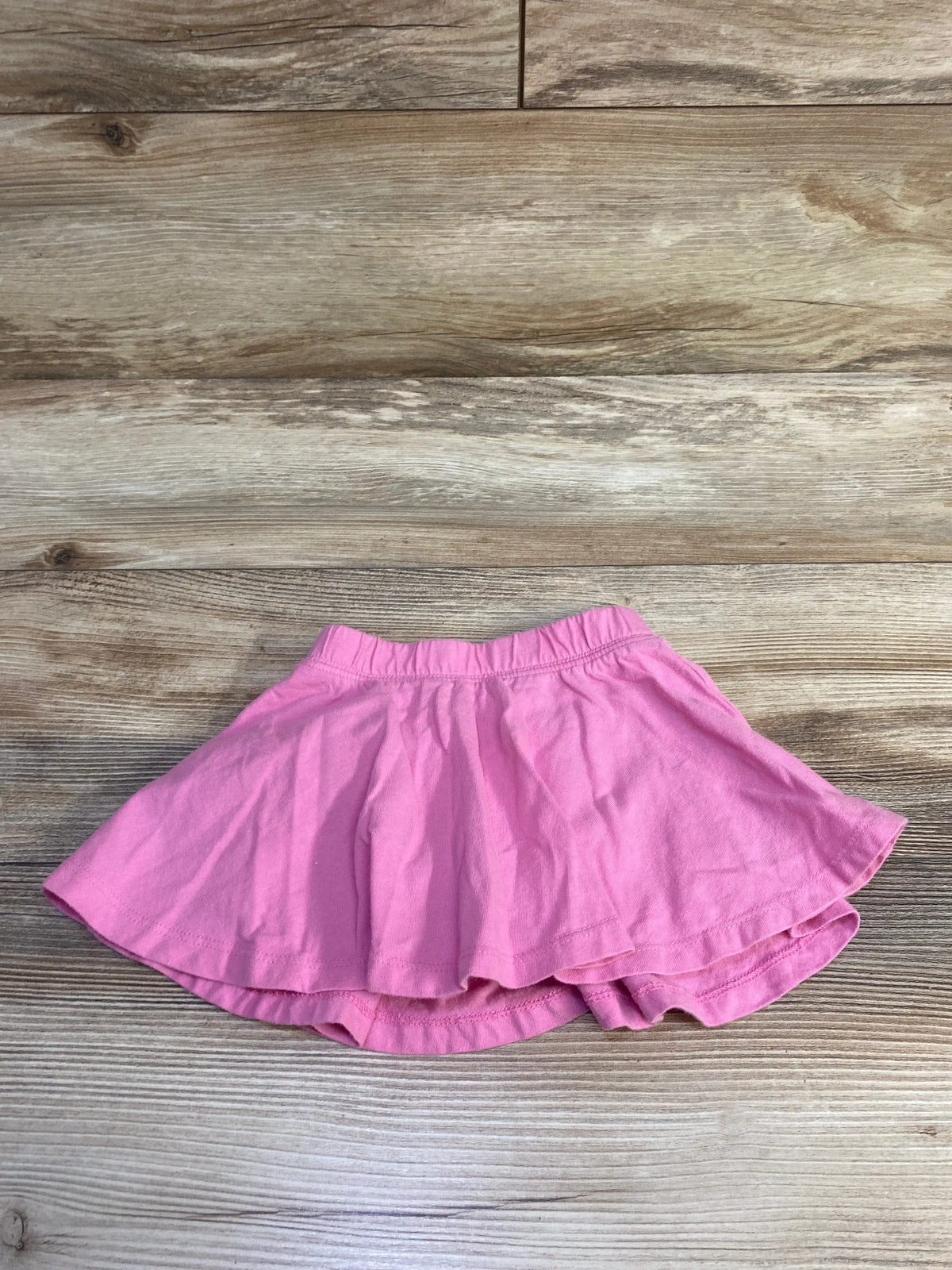 Baby Gap pull-on pink skort for infants size 12-18m on a wood background