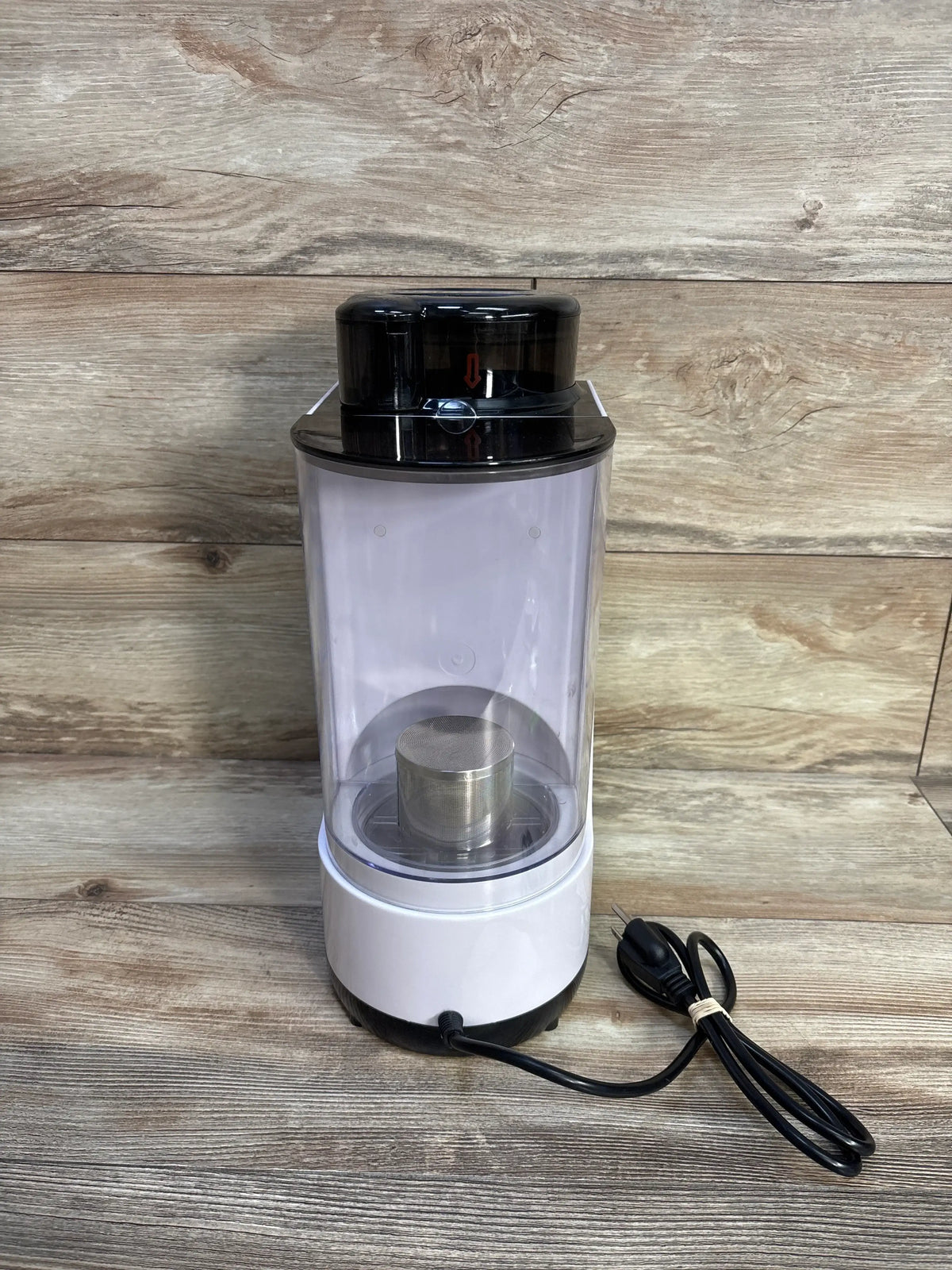 Front view of Baby EXO Smart Formula Maker and Dispenser showcasing clear mixing chamber on wood backdrop