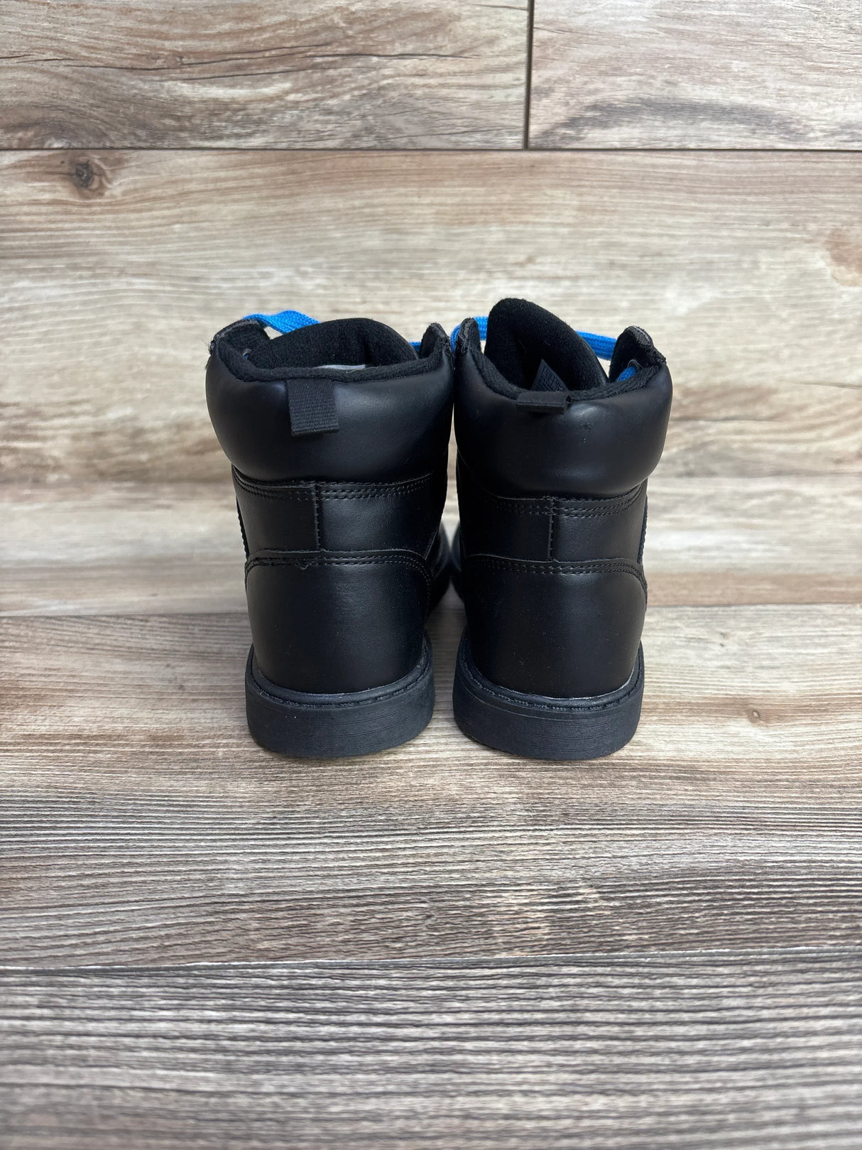 Rear view of Baby Gap toddler lace-up boots size 12C showcasing blue lining and laces on wood background