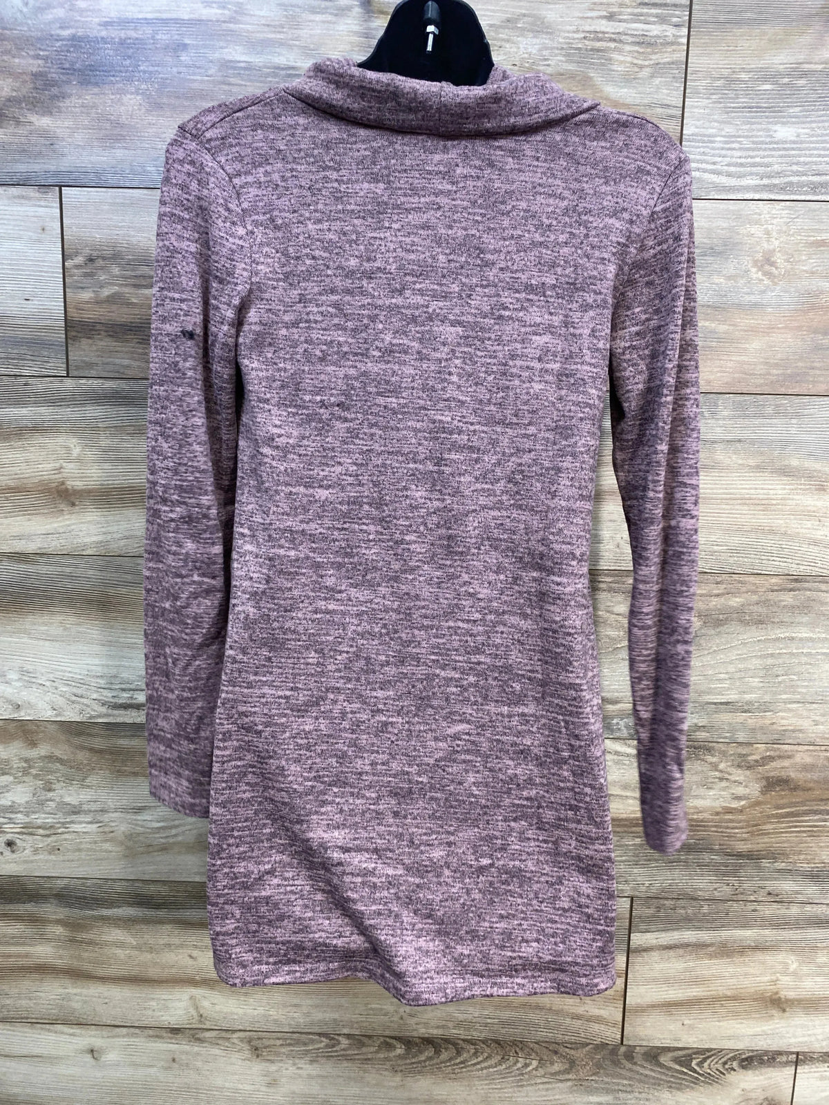 Back view of Hello MIZ shawl-collar maternity tunic sweater in mauve showing sleeves on black hanger against wood background