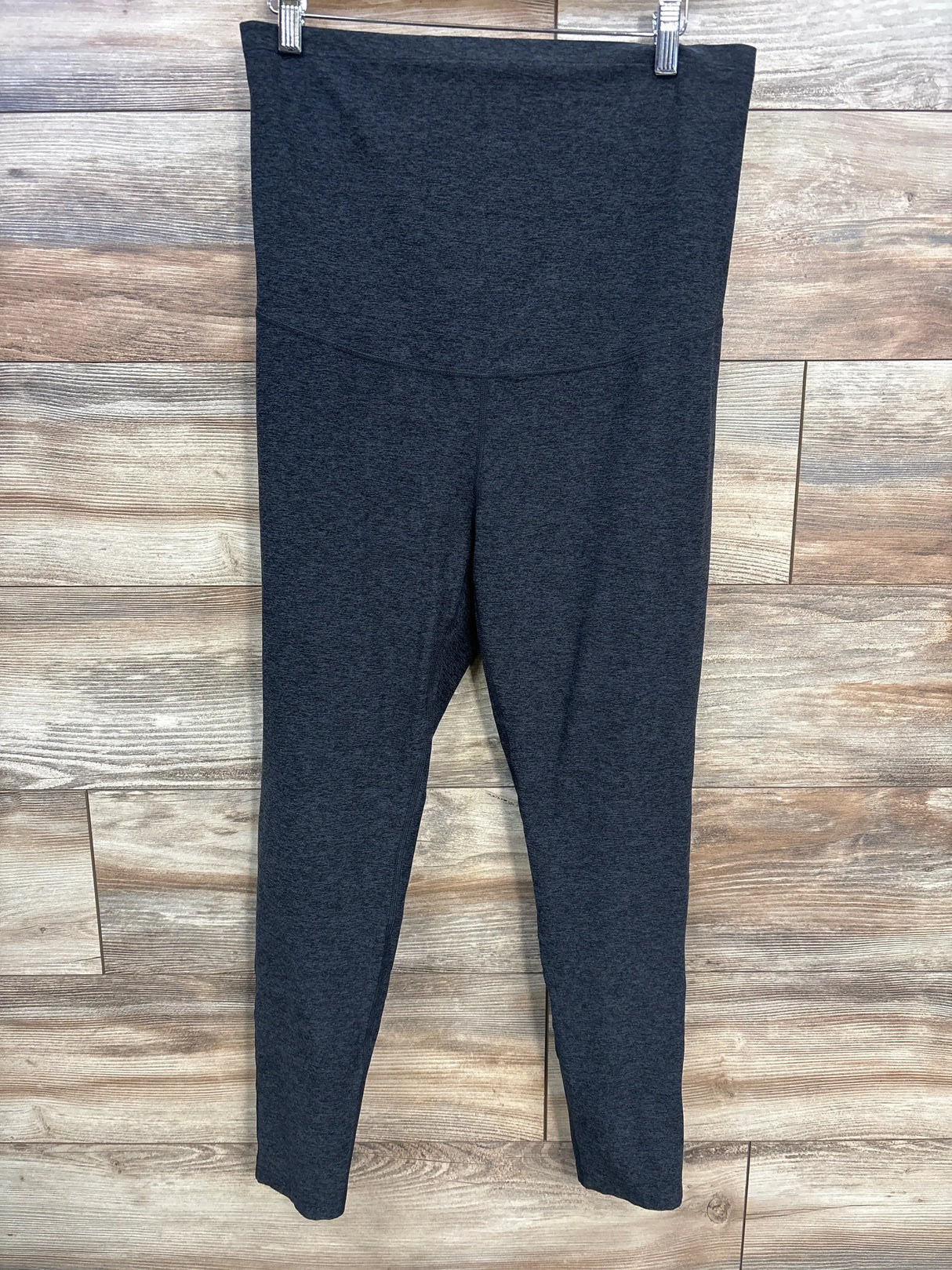 Front view of grey Zella maternity leggings size large showing high-rise full-panel waistband against wood background
