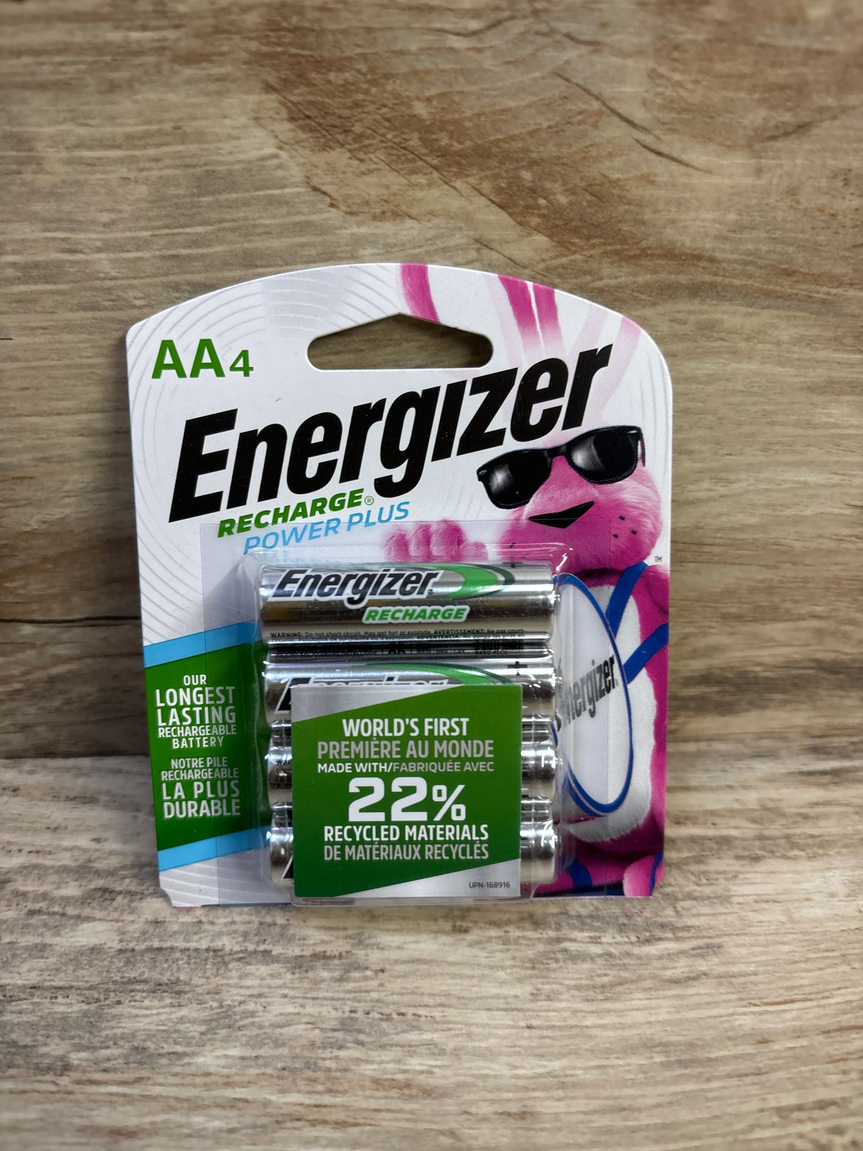 Front view of Energizer Recharge Power Plus AA 4-pack showing battery labels and green “22% recycled materials” badge on wooden surface