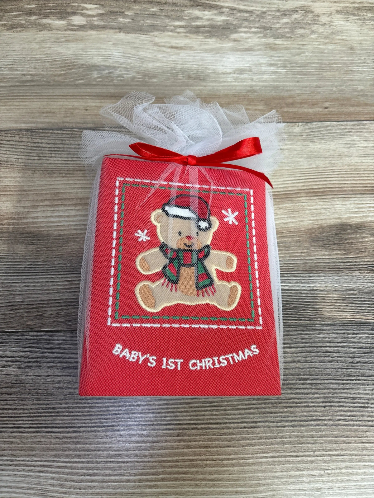 Baby's 1st Christmas keepsake with embroidered teddy bear in Santa hat, red ribbon, and tulle wrap