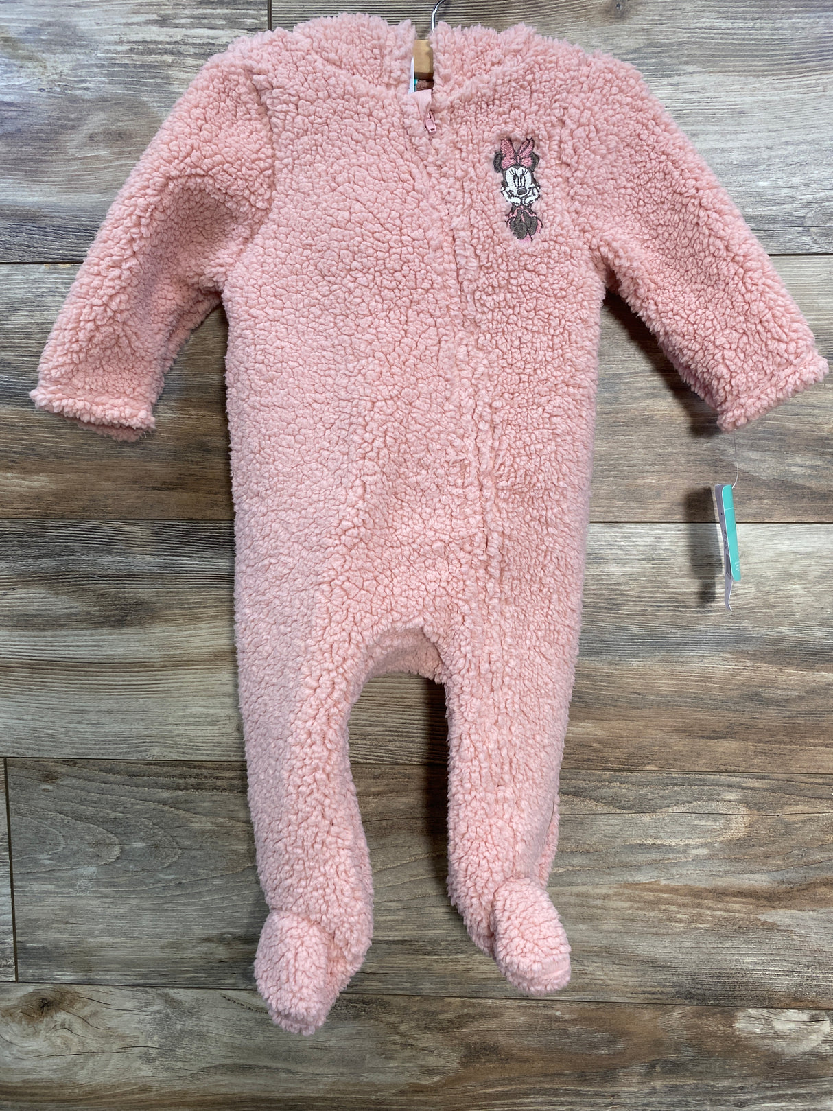 Pink fleece baby onesie with long sleeves, footed legs, and Minnie Mouse embroidery