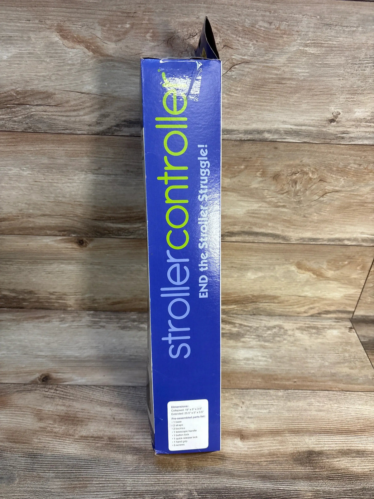 Stroller Controller product box with blue packaging on wood background, baby gear accessory