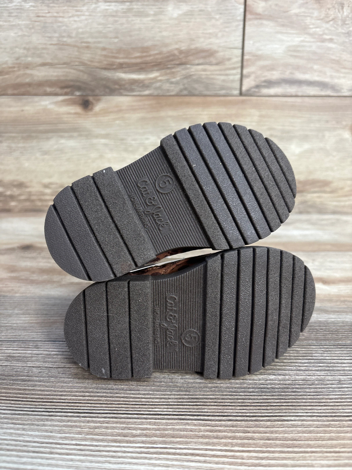 Cat & Jack toddler shoes size 5 with black ridged soles on wood floor