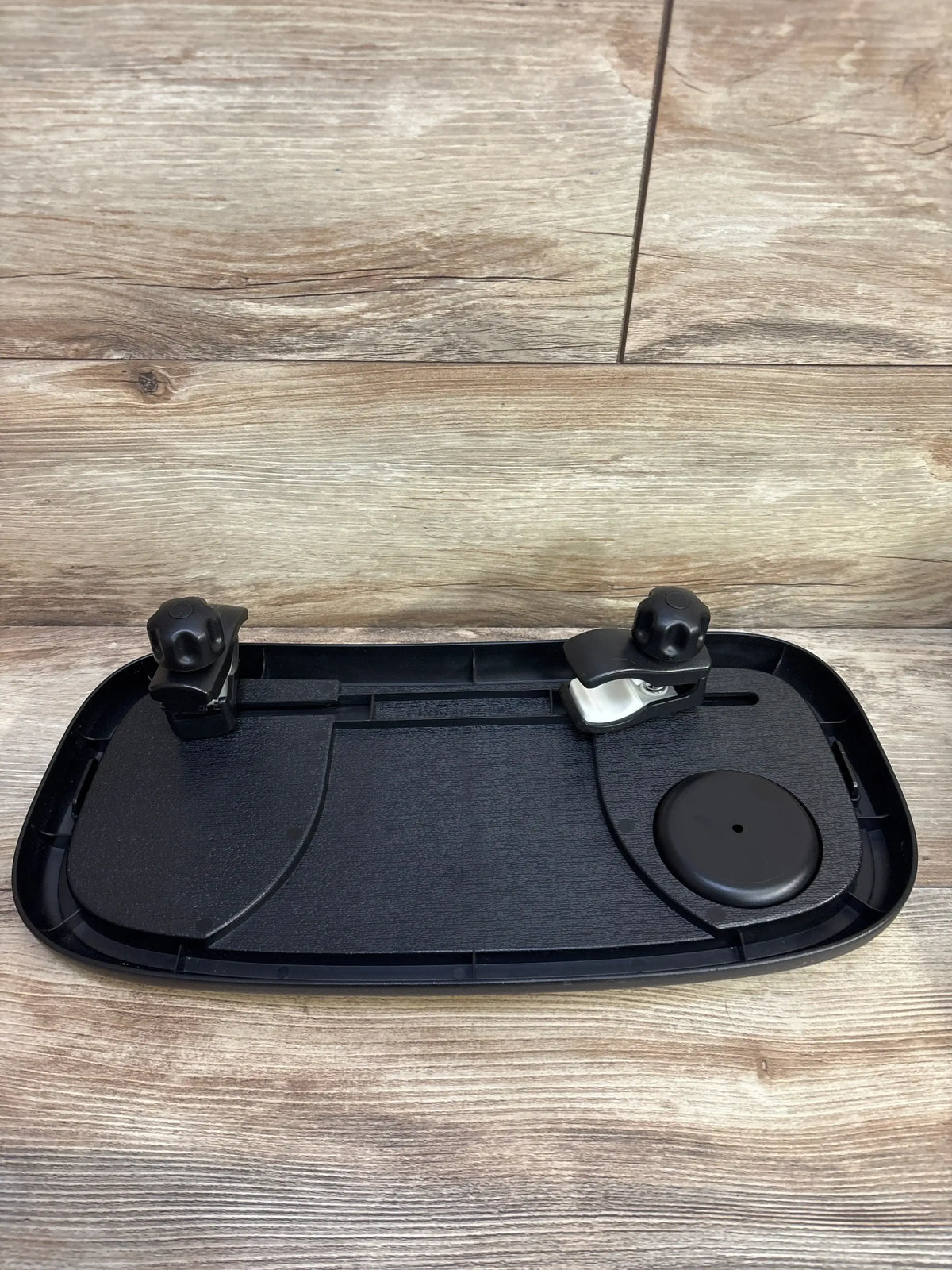 Angled view of Leadigol stroller snack tray with cup holder showcasing two clip buckles with wood-look floor background
