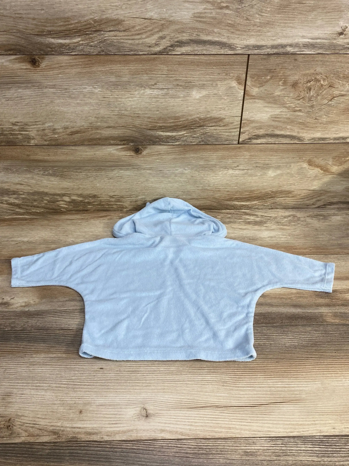 Back flat-lay of Old Navy baby terry swim cover-up hoodie, size 6-12 months, showing hood and wide sleeves on wood background