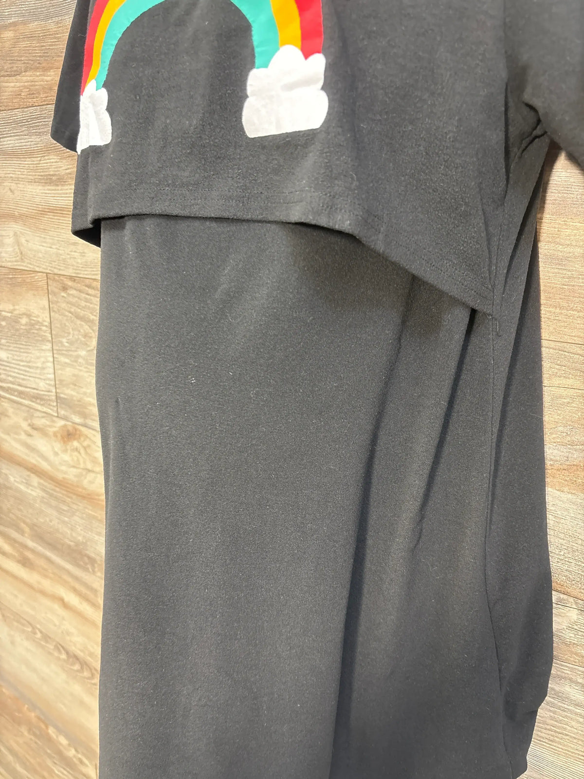 Close-up of a black Shein maternity nursing dress featuring a colorful rainbow graphic.