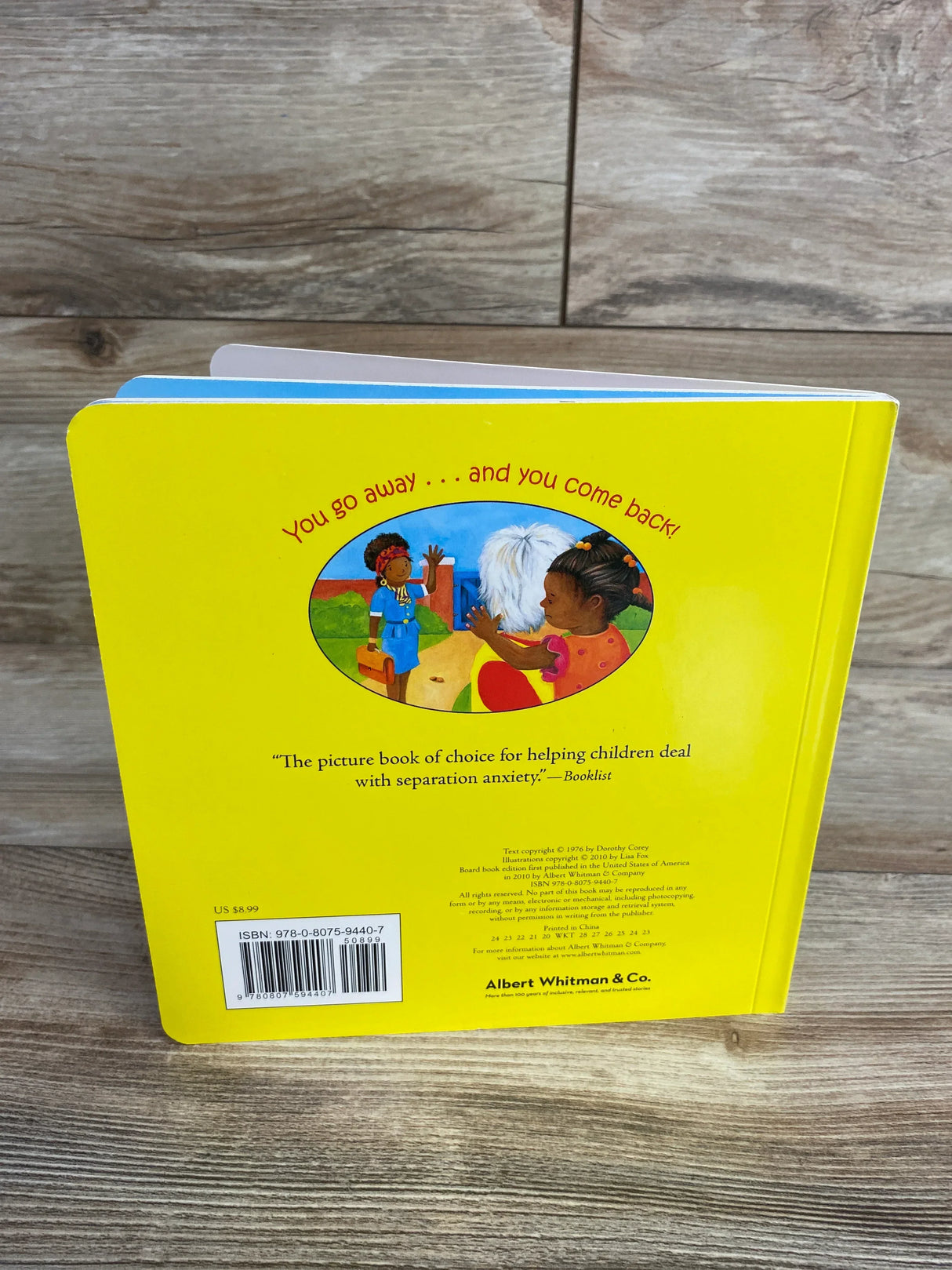 Back cover of a yellow children's board book with illustration of child and dog, ISBN visible.