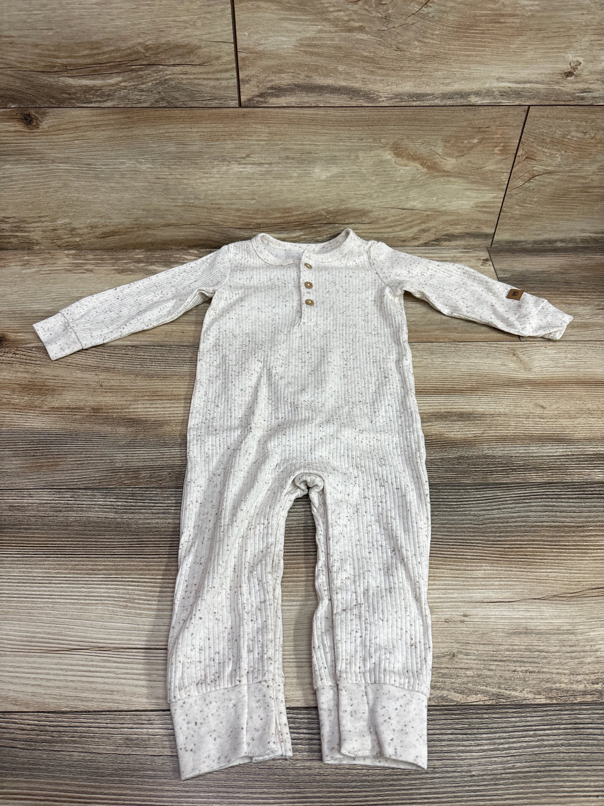 Carter's Ribbed Henley Coverall in ivory with speckled pattern, size 12m, on wood background
