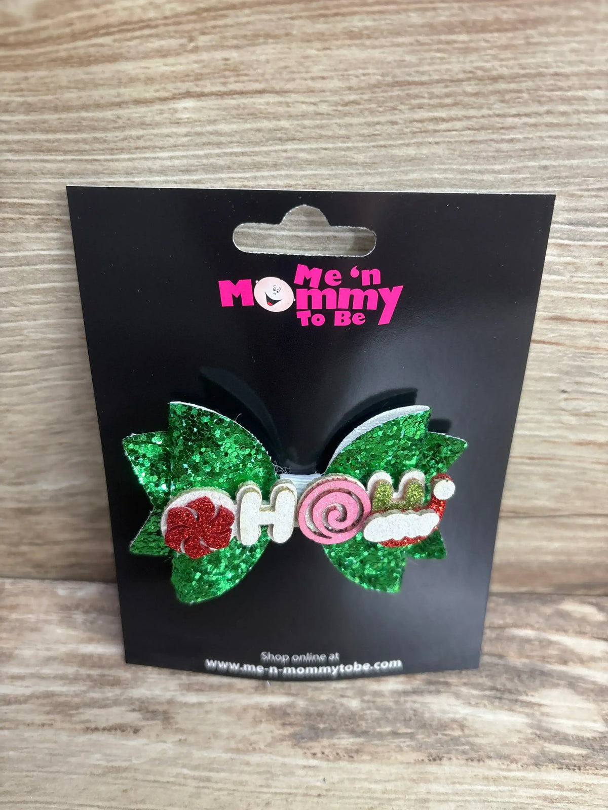 Glittery green holiday bow with 'HOHO' letters, candy cane, and Santa hat for kids' Christmas outfits