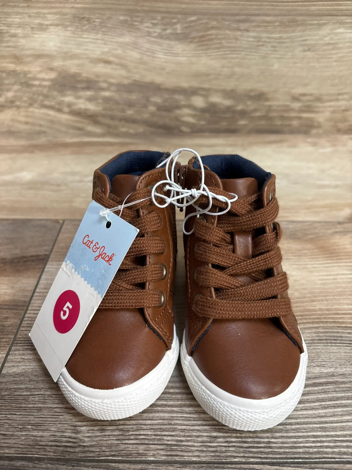 Cat & Jack brown toddler sneakers with tag, size 5, on wood background