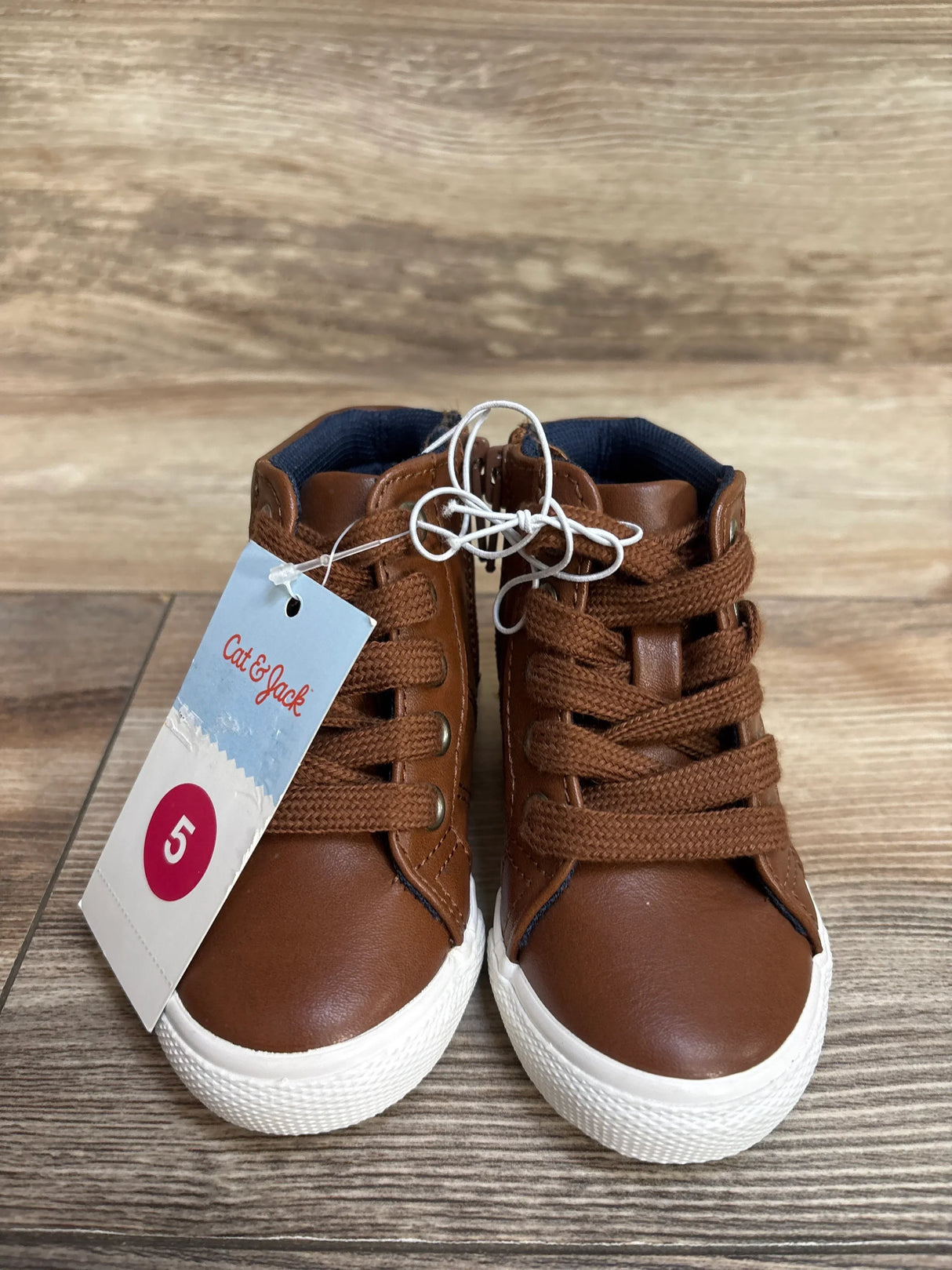 Cat & Jack brown toddler sneakers with tag, size 5, on wood background