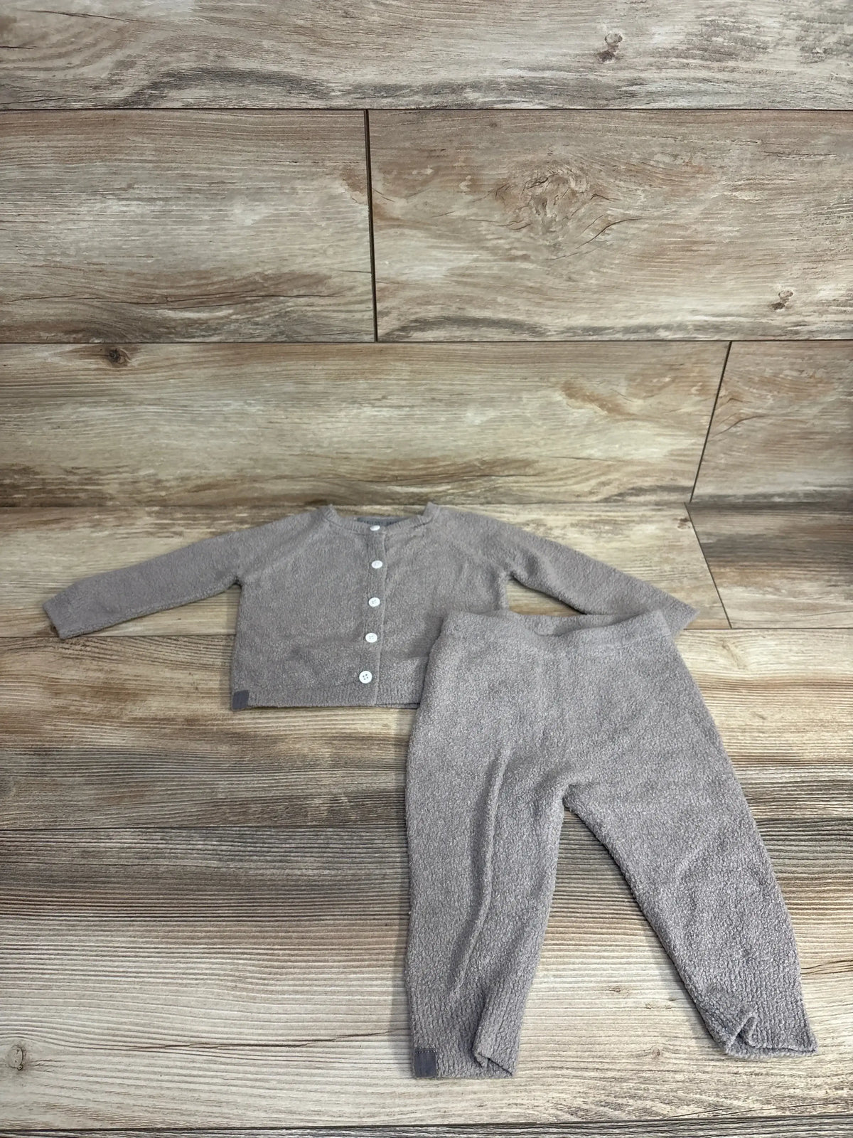 Gray toddler knit cardigan and pants set on wood background, gently used baby clothes