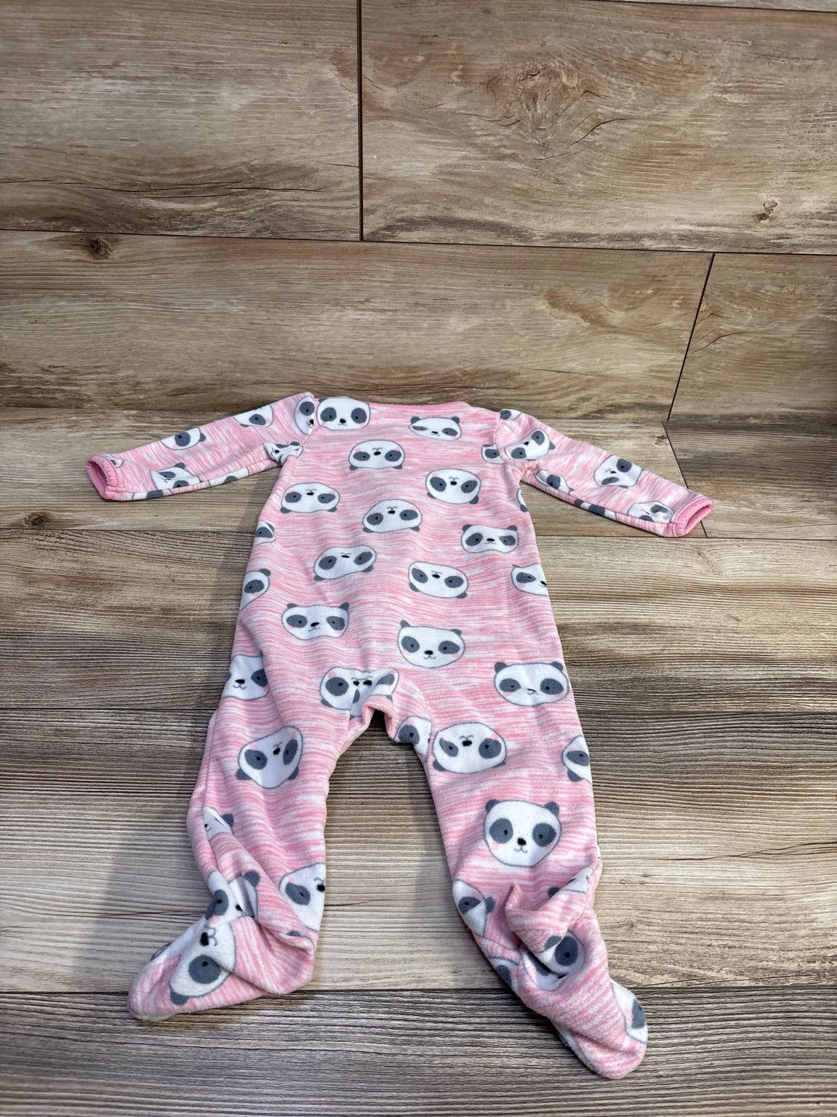 Front view of Simple Joys pink blanket sleeper showcasing long sleeves, footed legs, and panda print on a wood floor