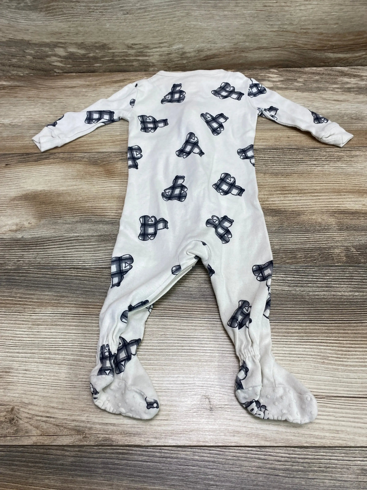Front flat-lay of Baby Gap footed sleeper (3-6 months) showing beige fabric with navy bear print and non-slip soles on wood
