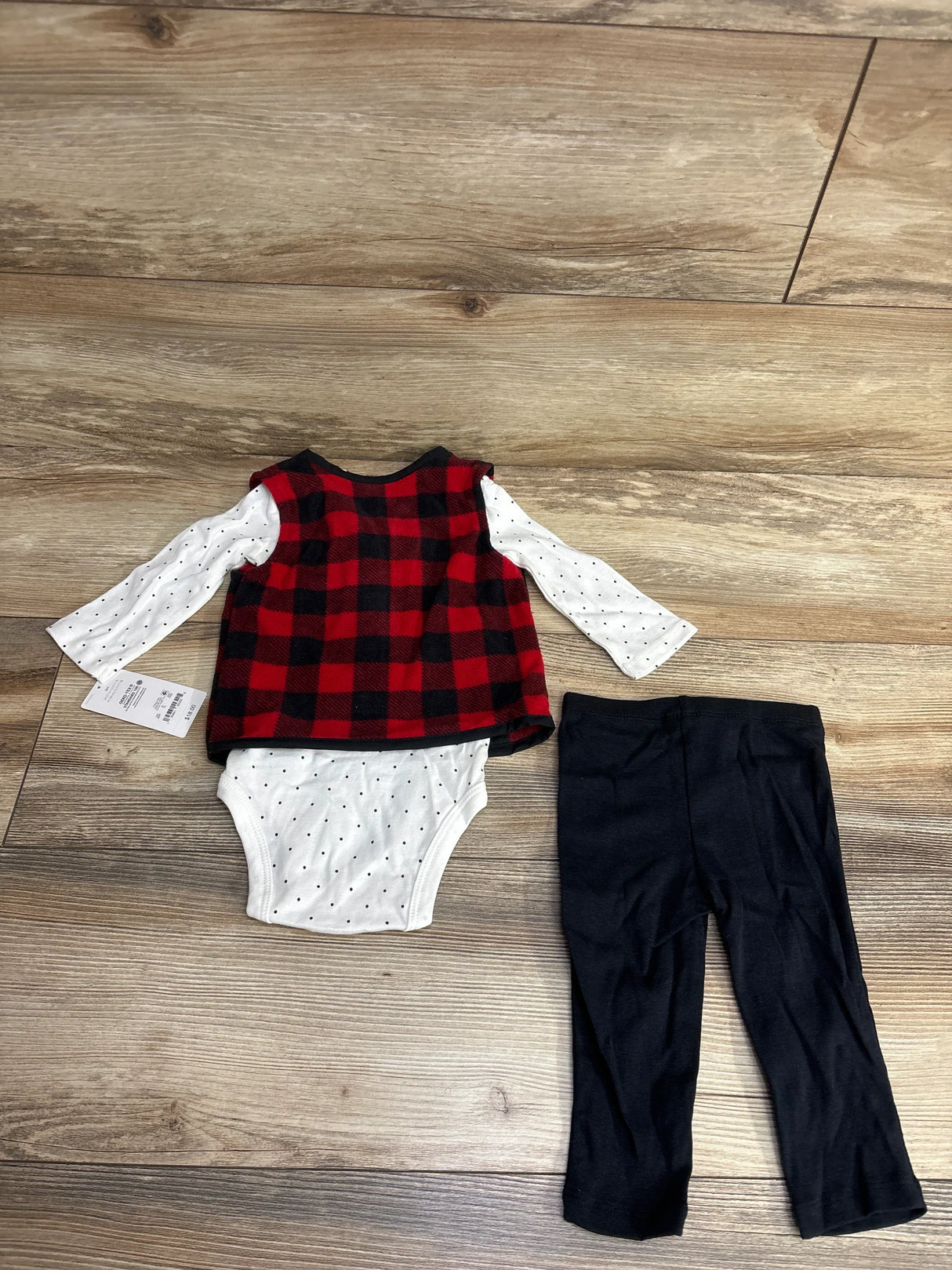 Baby outfit set with red plaid vest, white polka dot long-sleeve bodysuit, and black pants