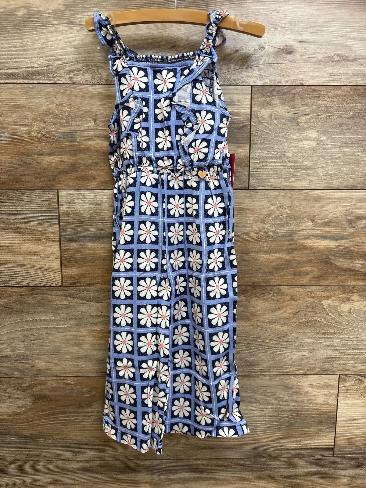 Front view of Vince Camuto 4T floral smocked jumpsuit in soft blue tones, showcasing sleeveless design and fitted smocked waist