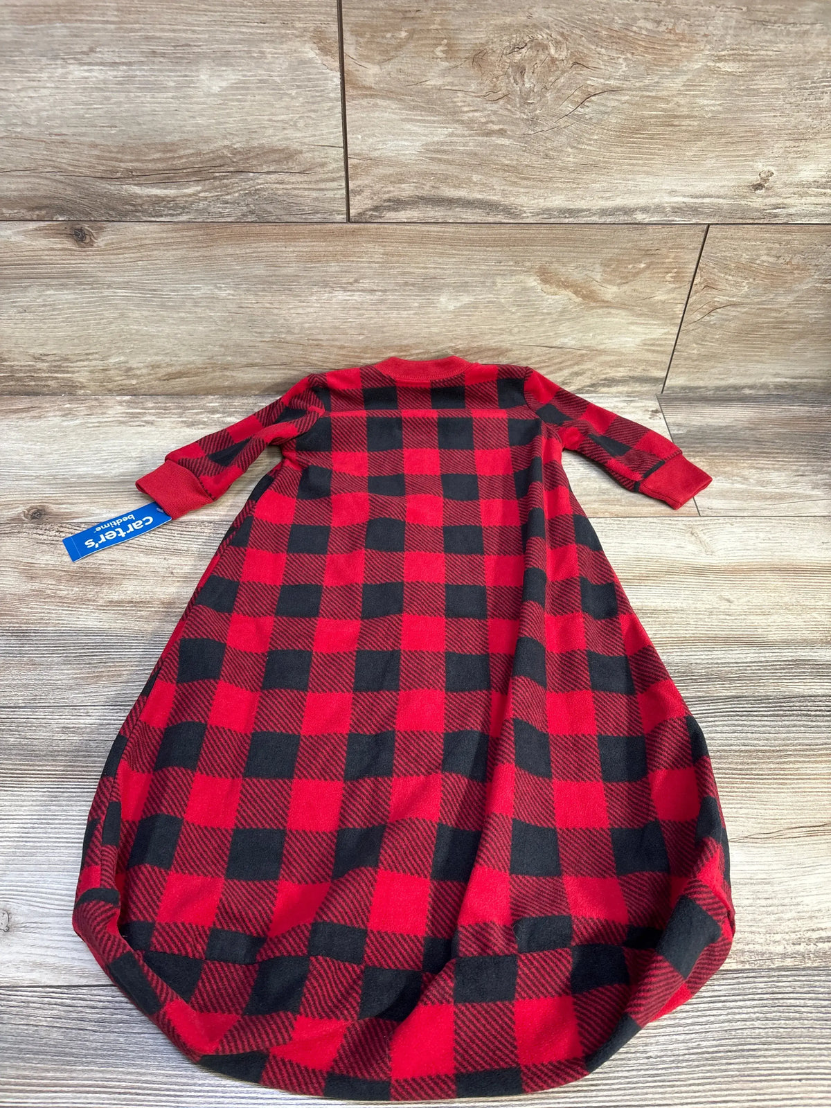 Front view of Carter’s red buffalo plaid sleep sack showcasing long sleeves and full-length wearable blanket design on a wood background