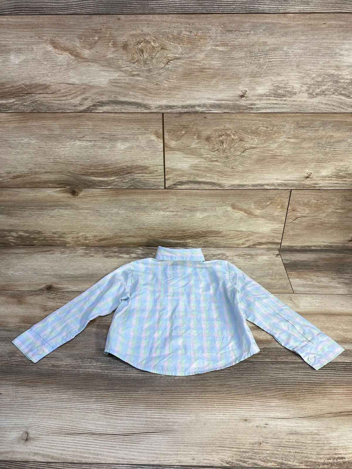 Back view of Tommy Hilfiger Button Up Shirt Blue sz 2T showcasing light blue and white plaid long-sleeve button-up on wood plank background