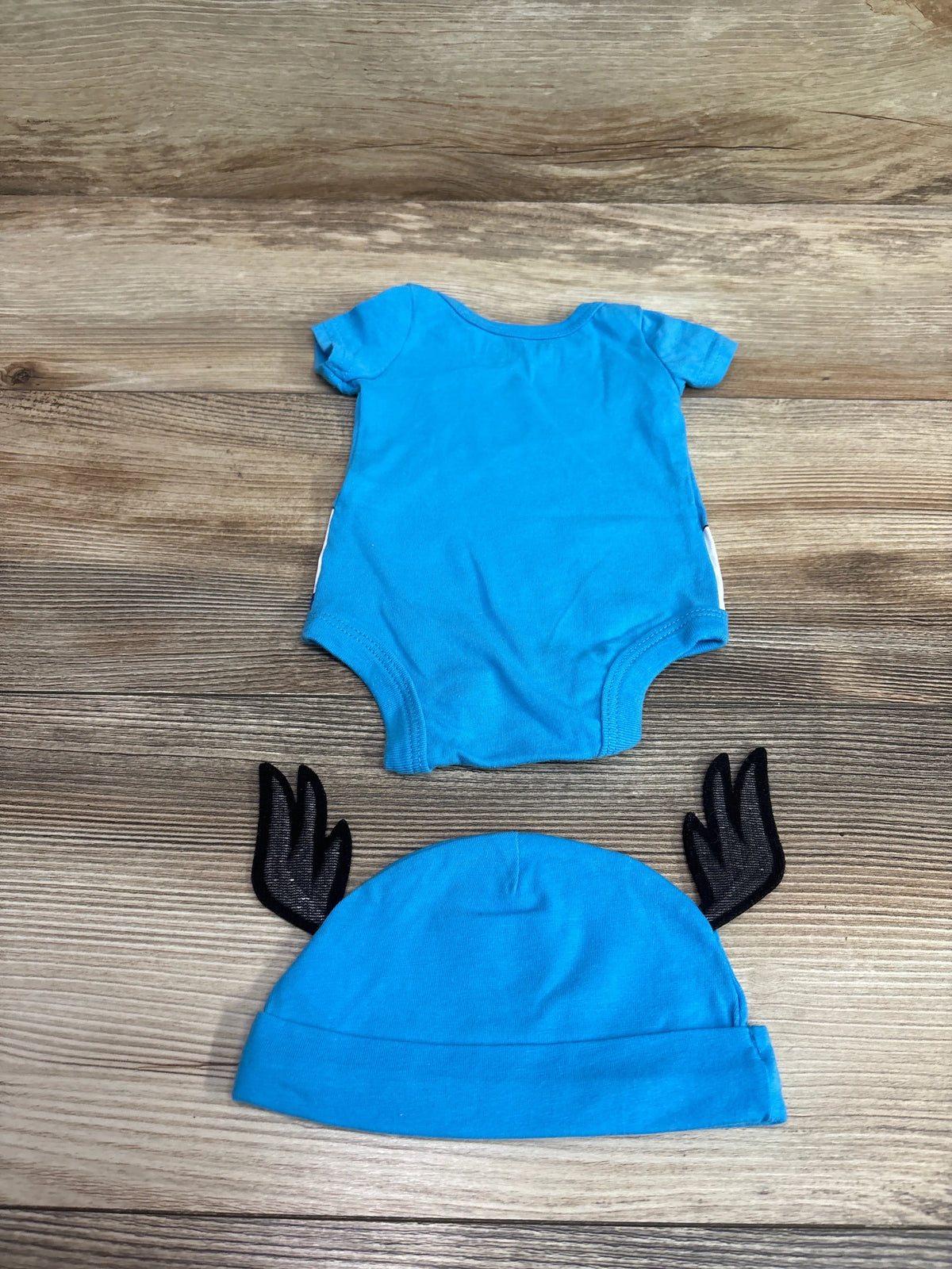 Marvel Captain America blue newborn bodysuit and matching hat set.