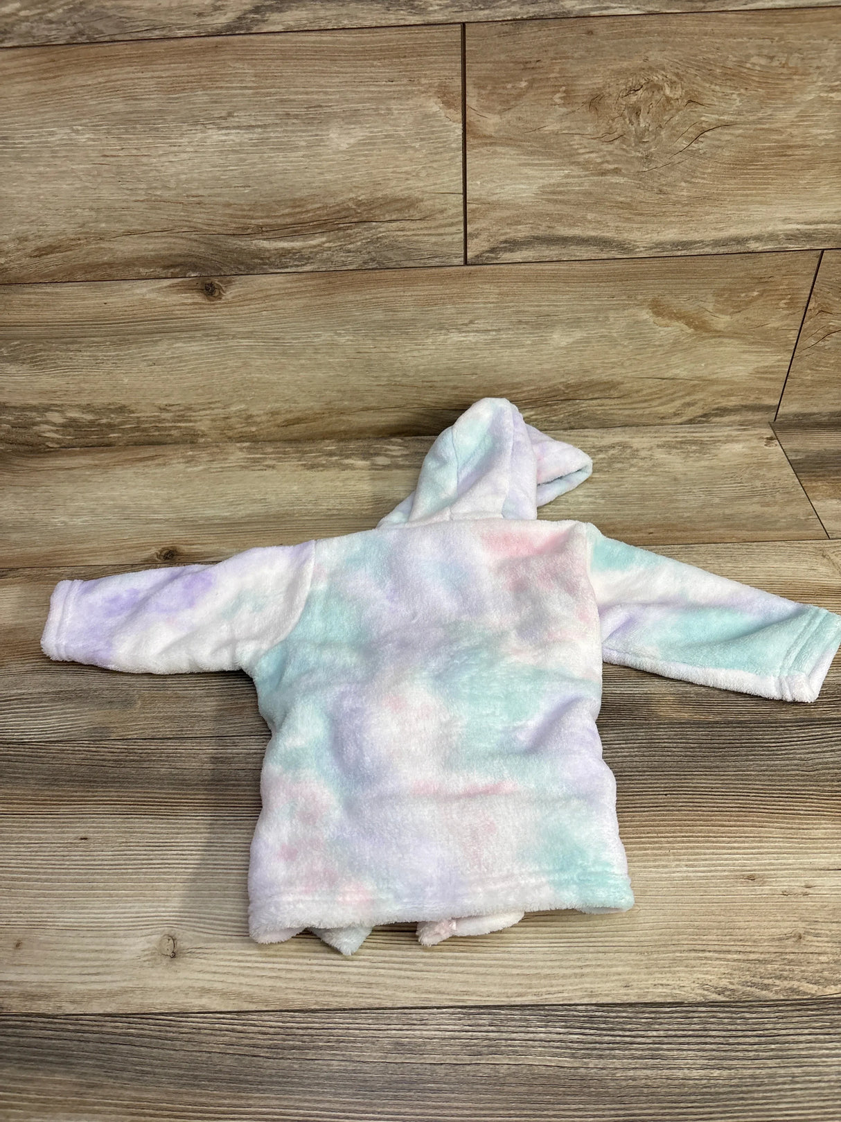 Soft pastel tie-dye baby hooded jacket on wooden floor, kids clothing resale