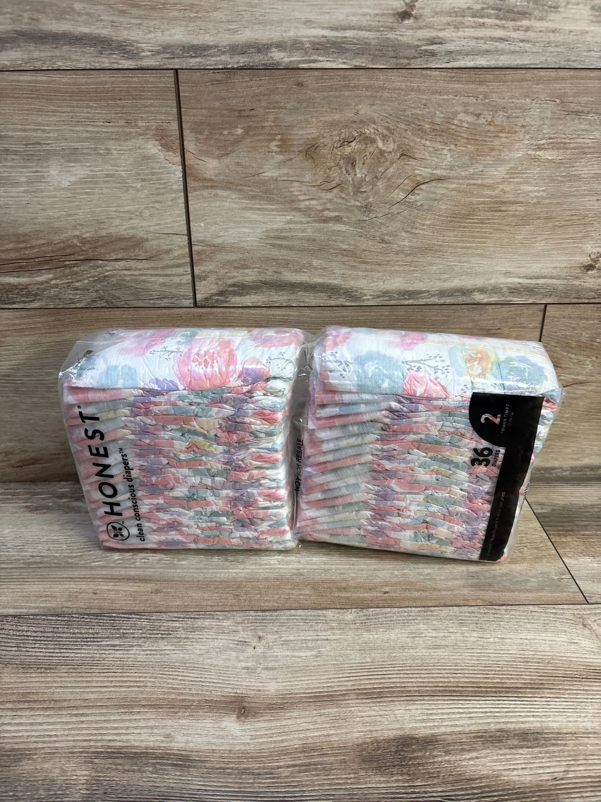 Two packs of Me n Mommy To Be size 2 clean conscious diapers with floral prints