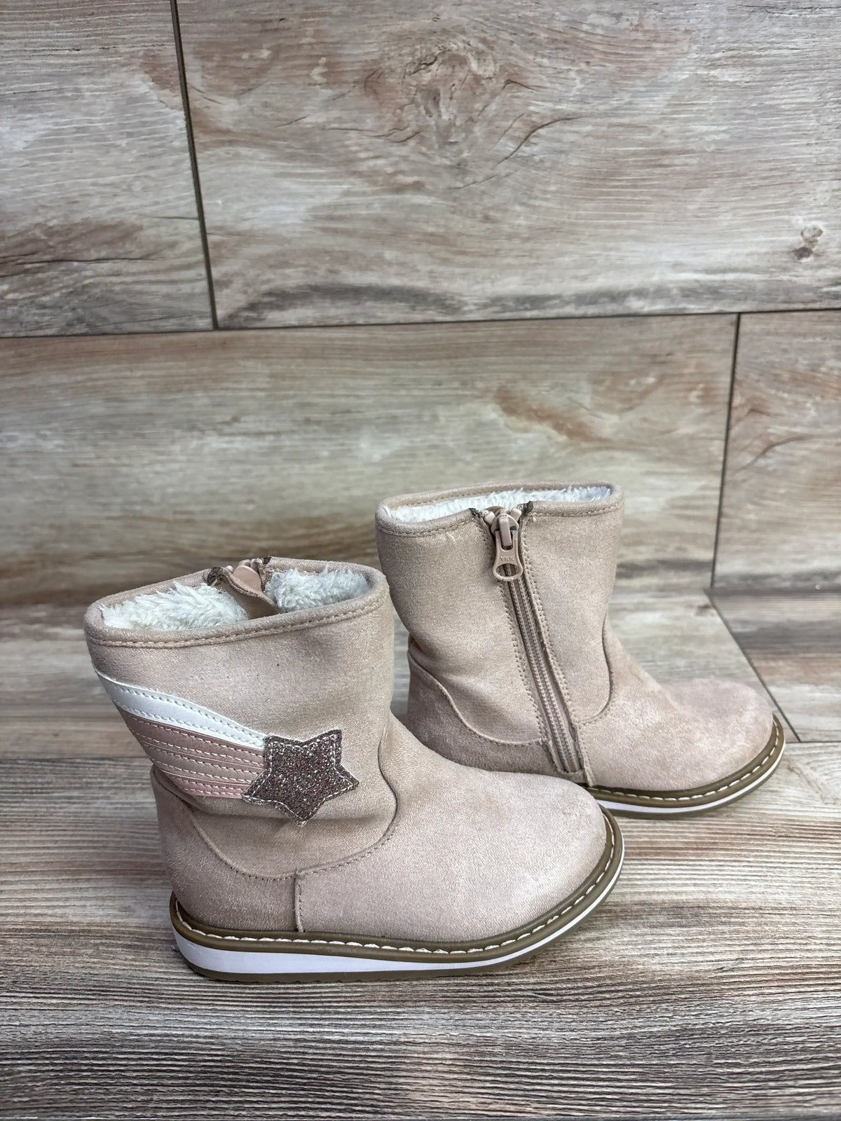 Angled view of Cat & Jack Isla suede toddler zipper boots, pink, showing faux fur cuff and side zipper on wood floor