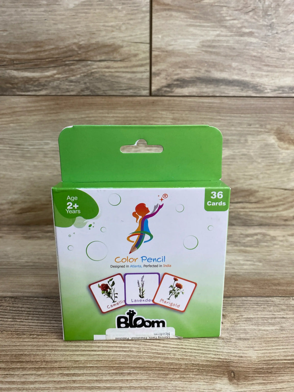 Front view of Bloom Color Pencil flashcards box showing age 2+ badge, '36 Cards' label, and flower card images on wooden background