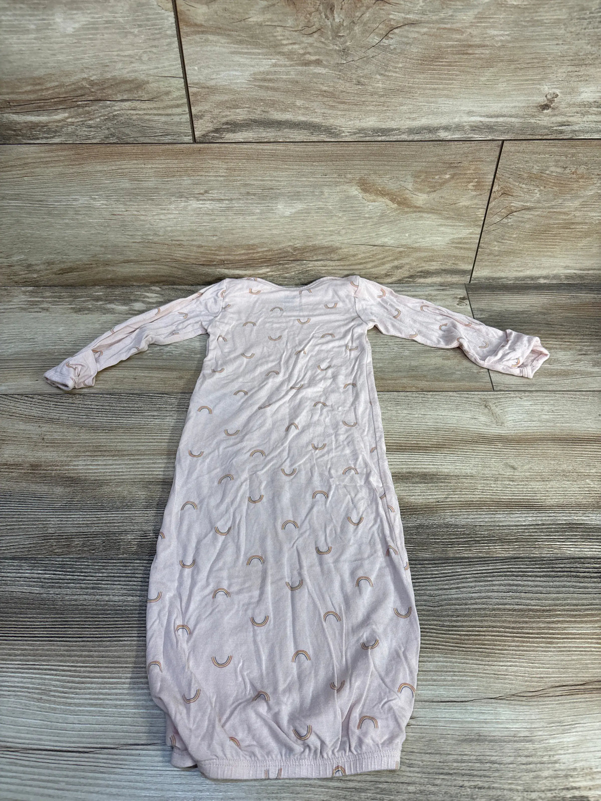 Front view of Carter’s PurelySoft sleep gown in soft pink showcasing rainbow print, long sleeves, and fold-over cuffs on a wood-look floor