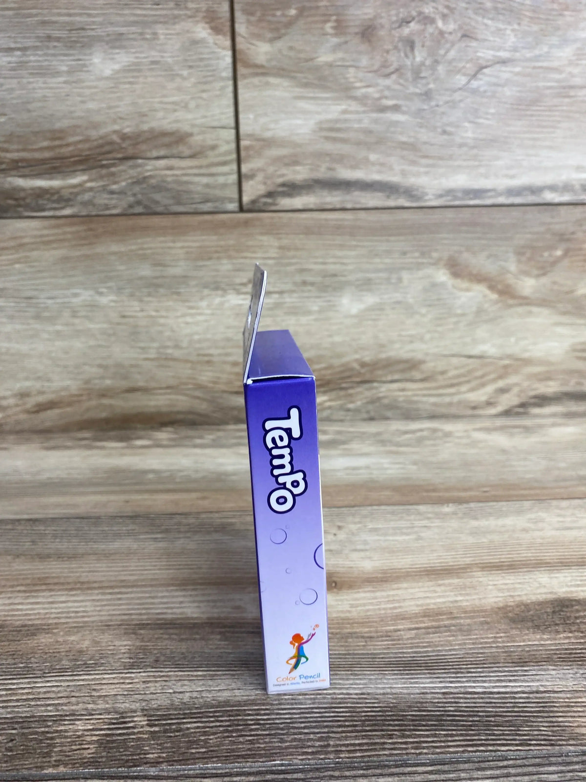 Side view of Color Pencil Flashcards Tempo 36ct showcasing purple Tempo packaging with an open flap on a wood background