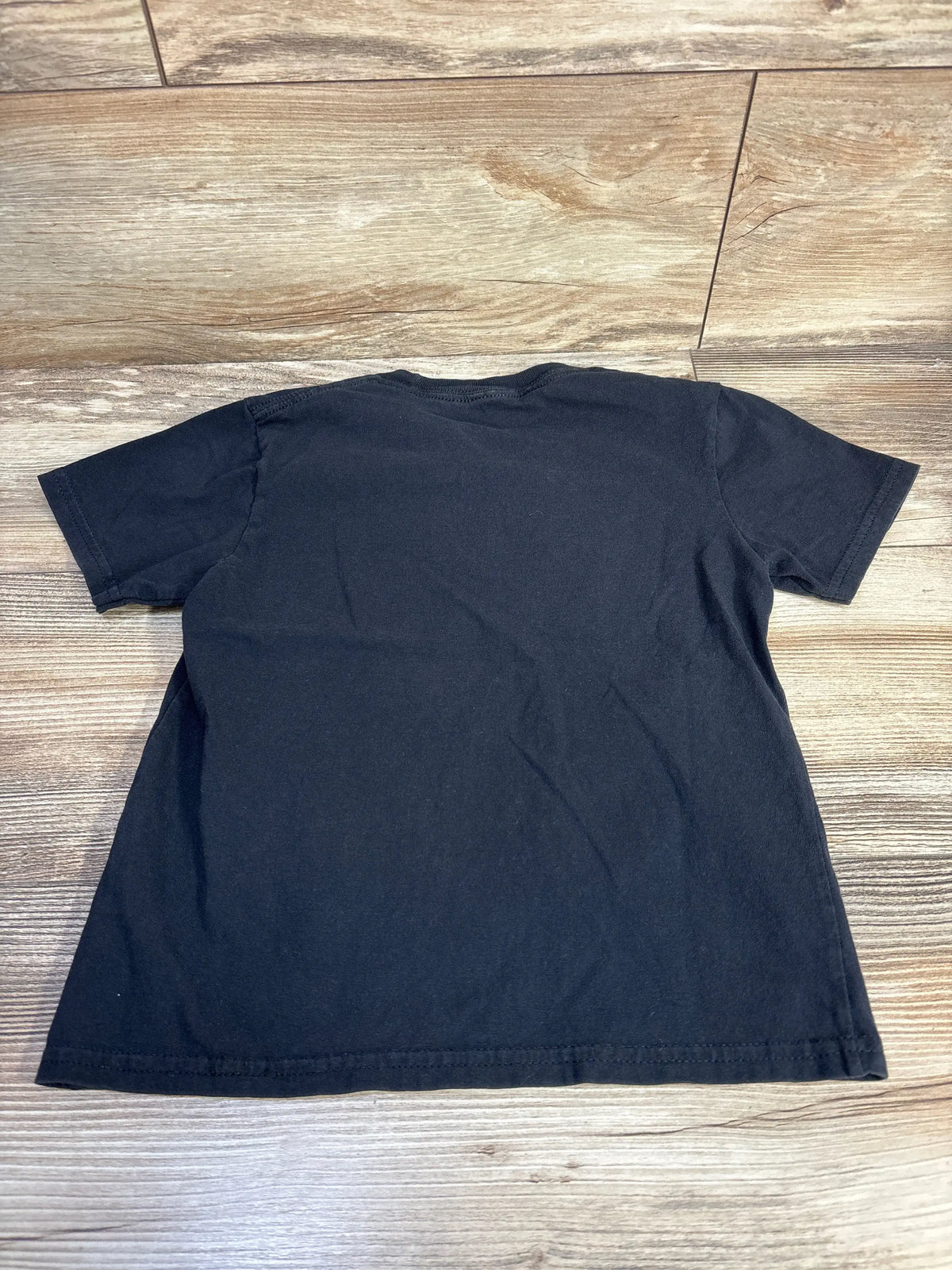 Back view of Siren Head shirt in black, size 5/6T, showing short sleeves and relaxed fit on a wood floor