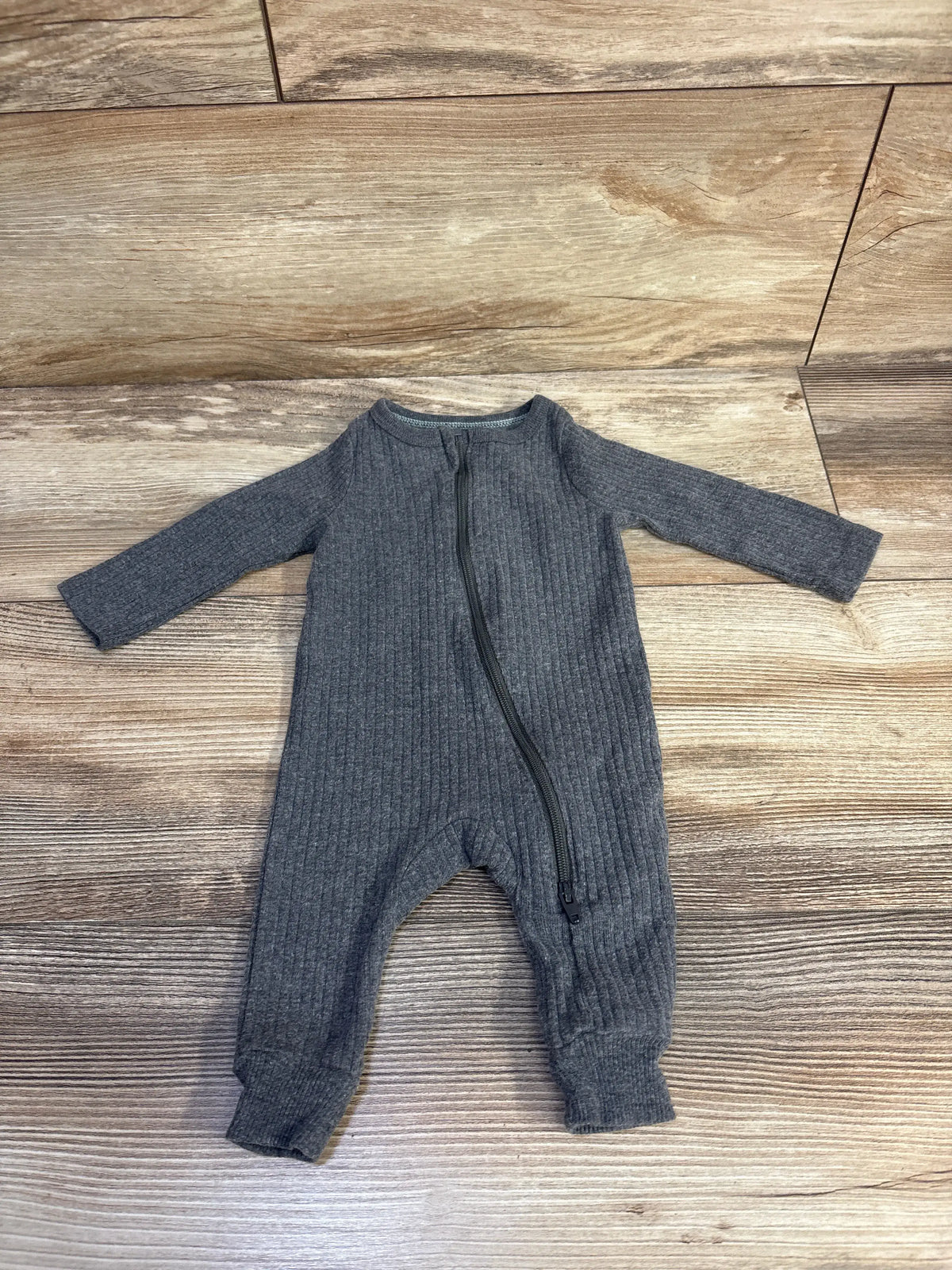 Front view of Cloud Island newborn grey ribbed ruffle sleeper showcasing long sleeves and front zipper with wood-look background