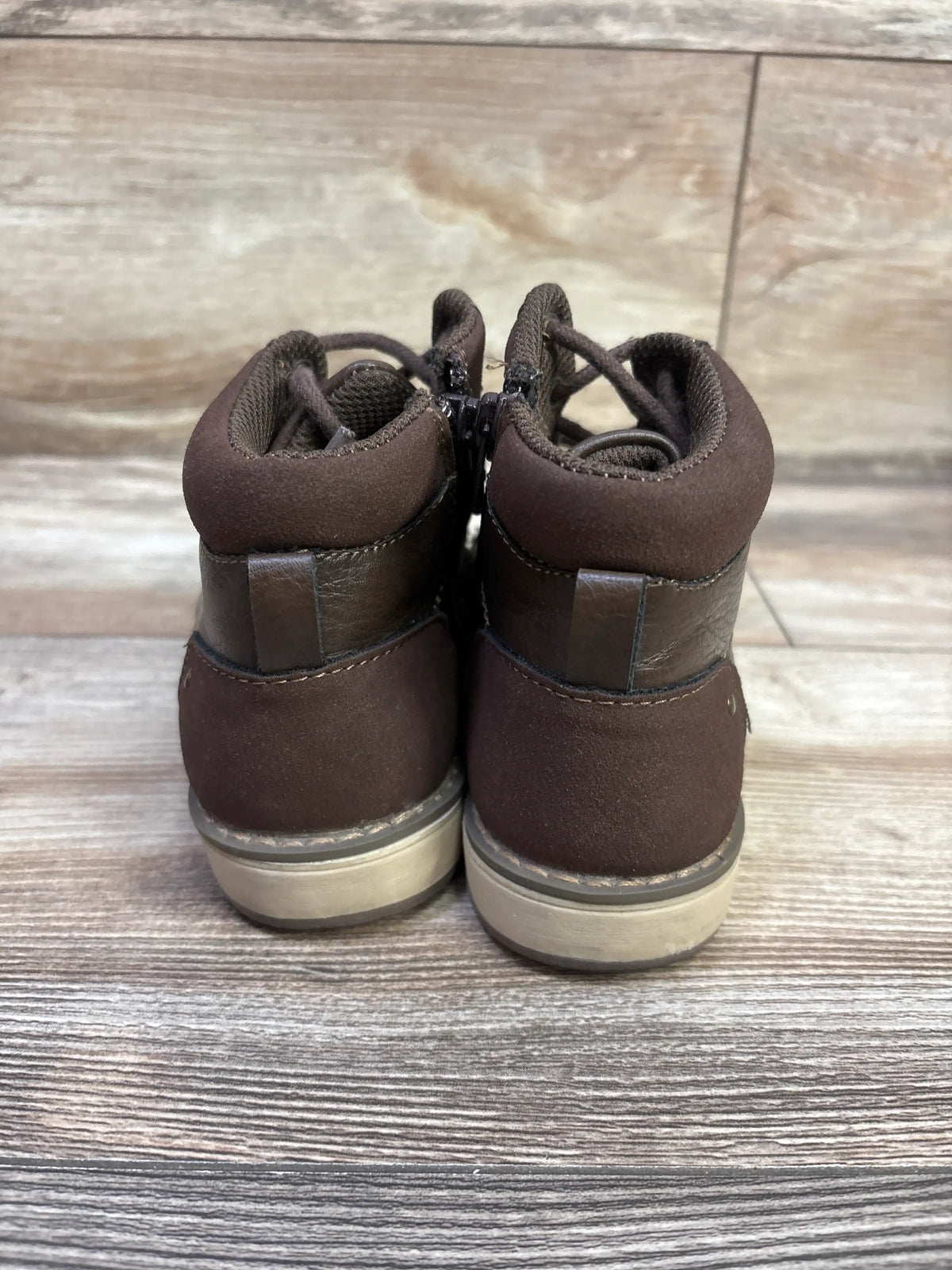 Rear view of brown Sonoma Goods for Life Joshua lace-up boots showcasing padded collars and contrast soles on a wood surface