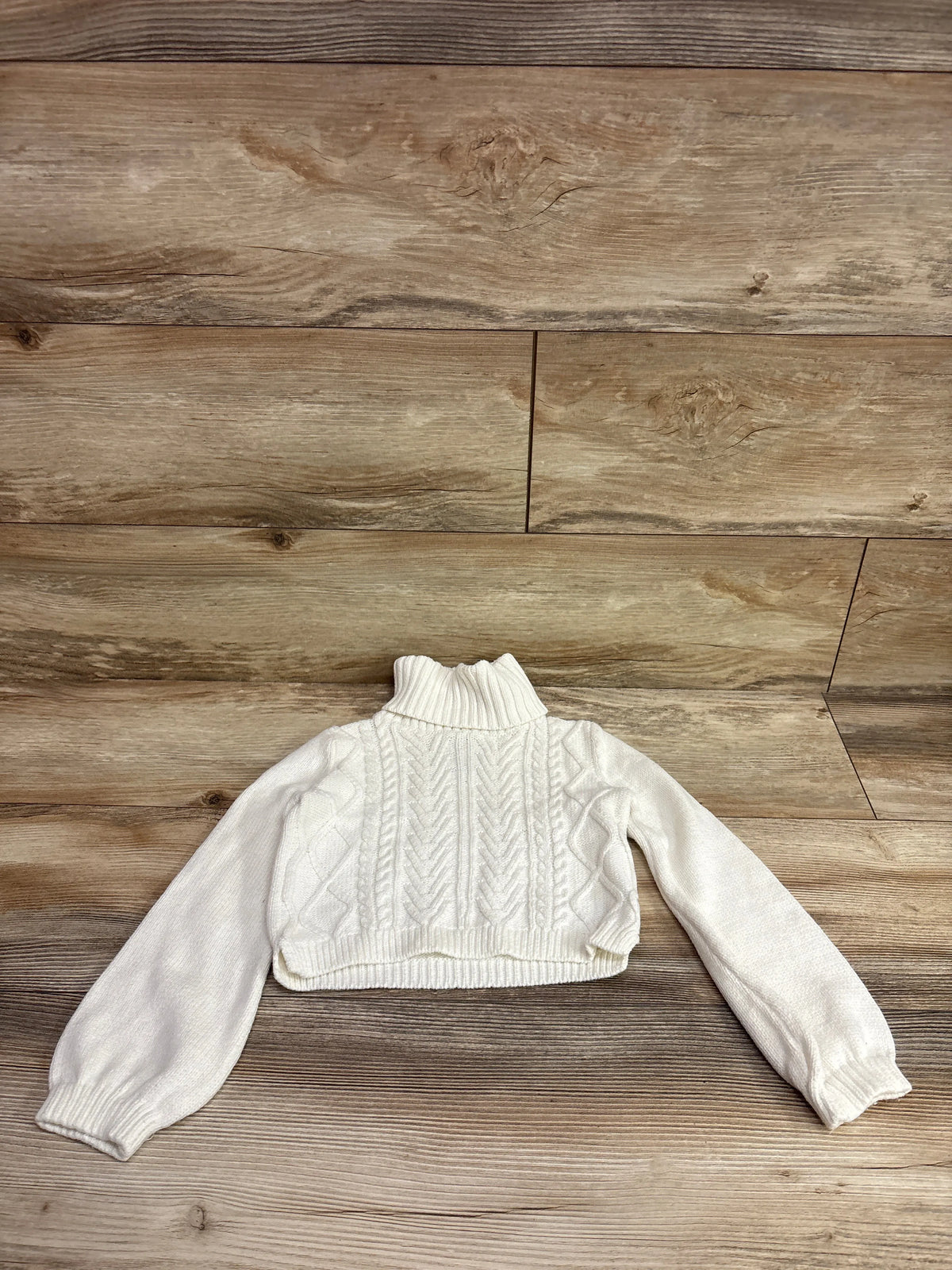White Rachel Zoe cable knit turtleneck sweater for girls, size 5/6T, on a wooden background